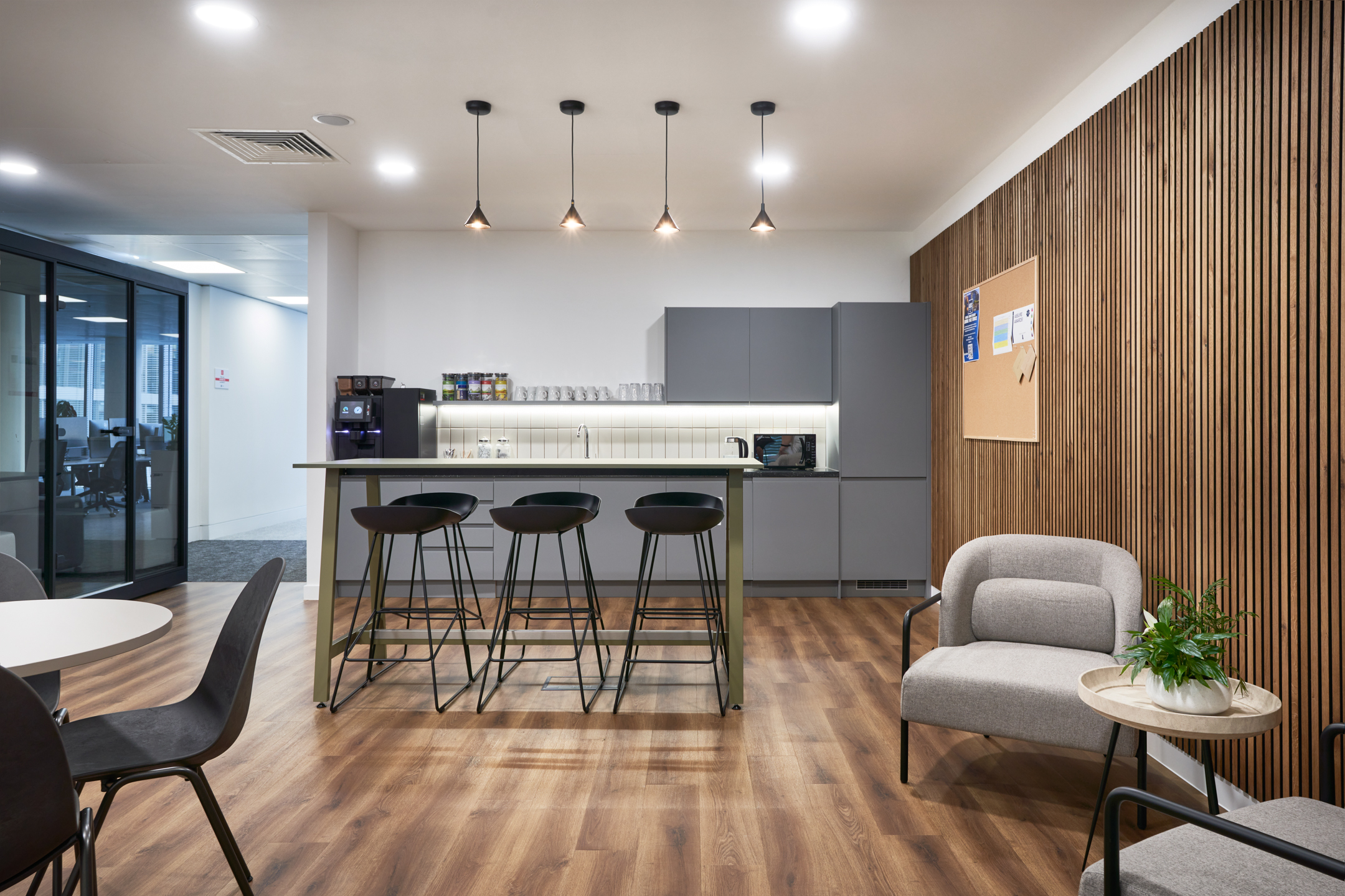Teapoint area at LGC featuring modern furniture supplied by Platfform, including bar stools, soft seating, and a high table.