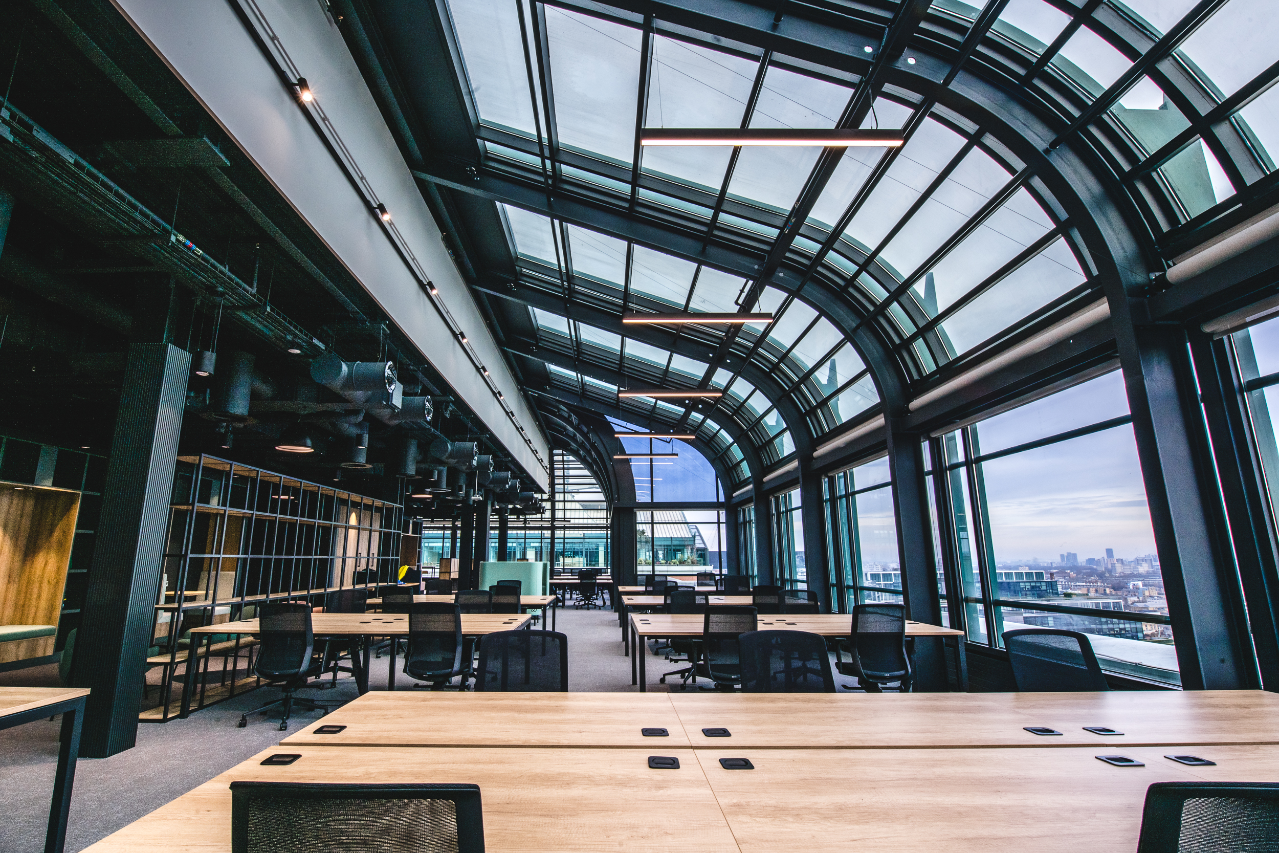 Open-plan office at 135 Bishopsgate with curved glass roof, furnished by Platfform for British Land to optimise natural light and workspace layout.