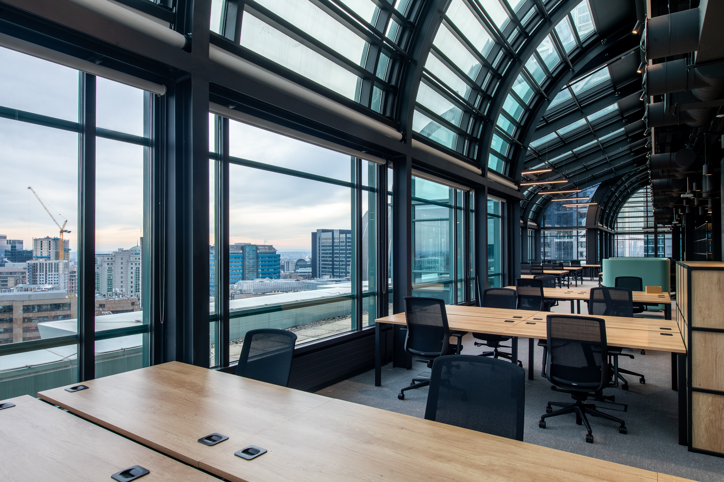 Glass-roofed office interior at 135 Bishopsgate with panoramic city views, furnished by Platfform for British Land to support collaborative working.