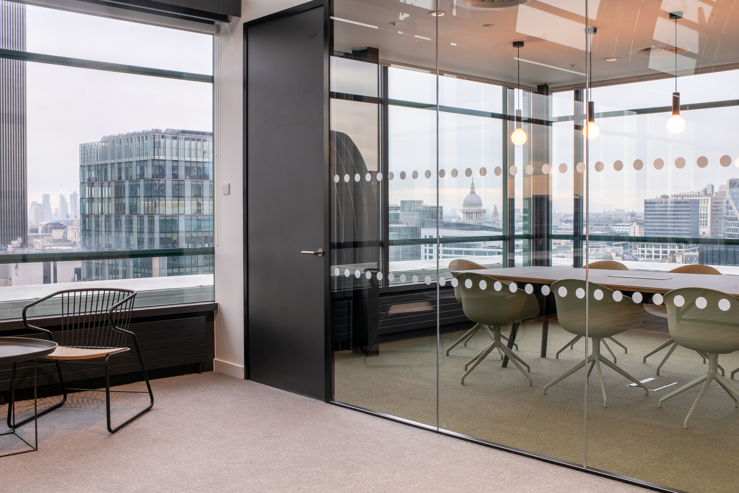 Glass-fronted meeting room at 135 Bishopsgate with views of St Paul’s, furnished by Platfform for British Land with modern, minimalist pieces.