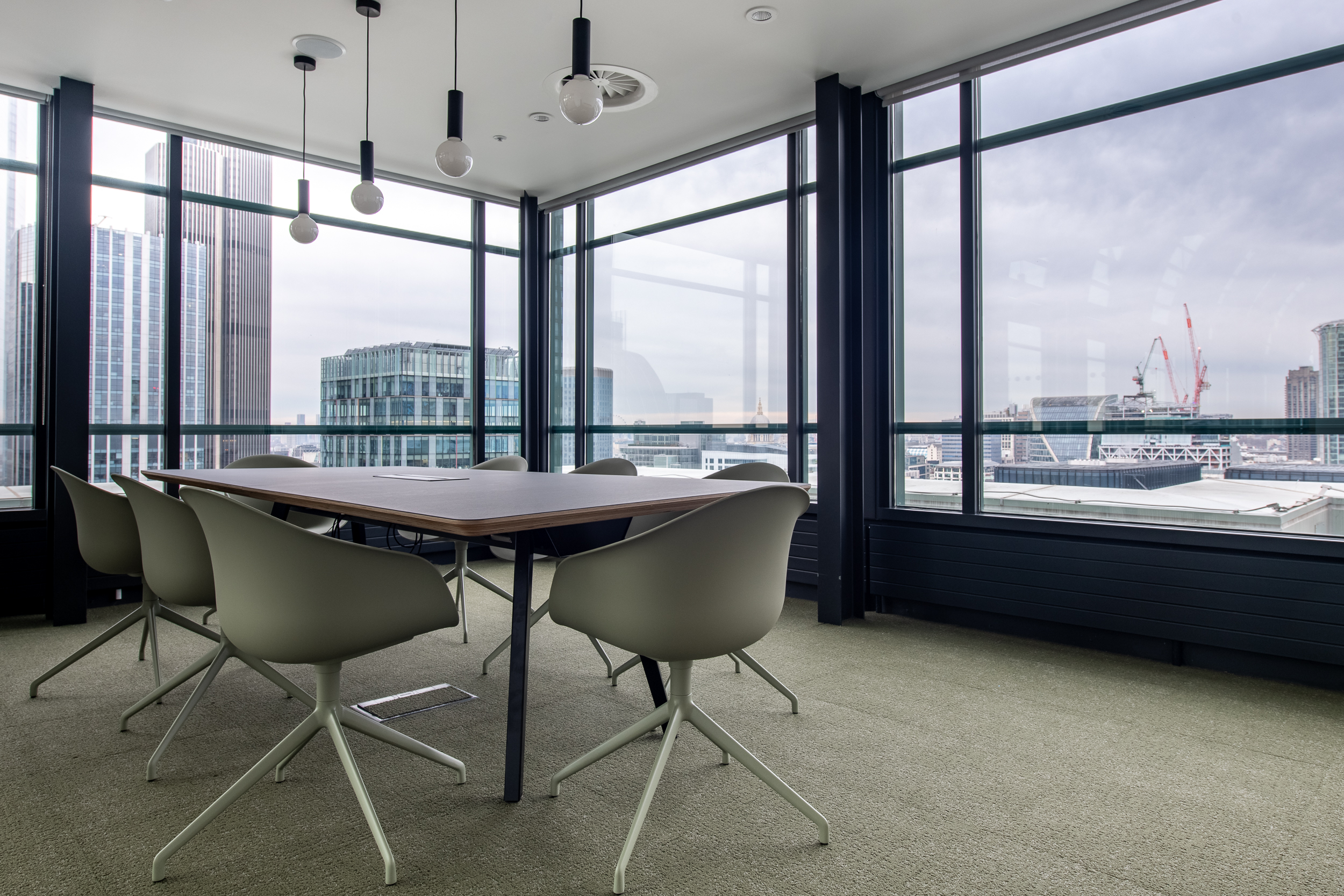 Meeting room at 135 Bishopsgate with neutral-toned furniture by Platfform for British Land, surrounded by full-height glazing and skyline views.