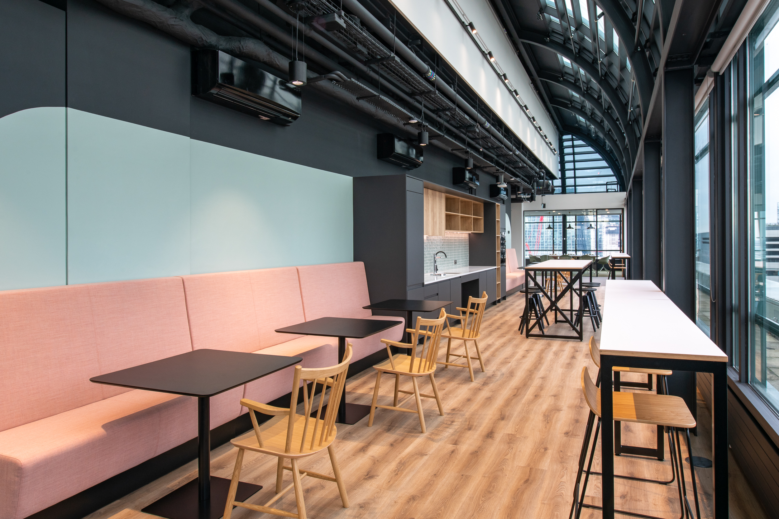 Teapoint space at 135 Bishopsgate featuring pastel seating, timber finishes and a kitchenette, furnished by Platfform for British Land.