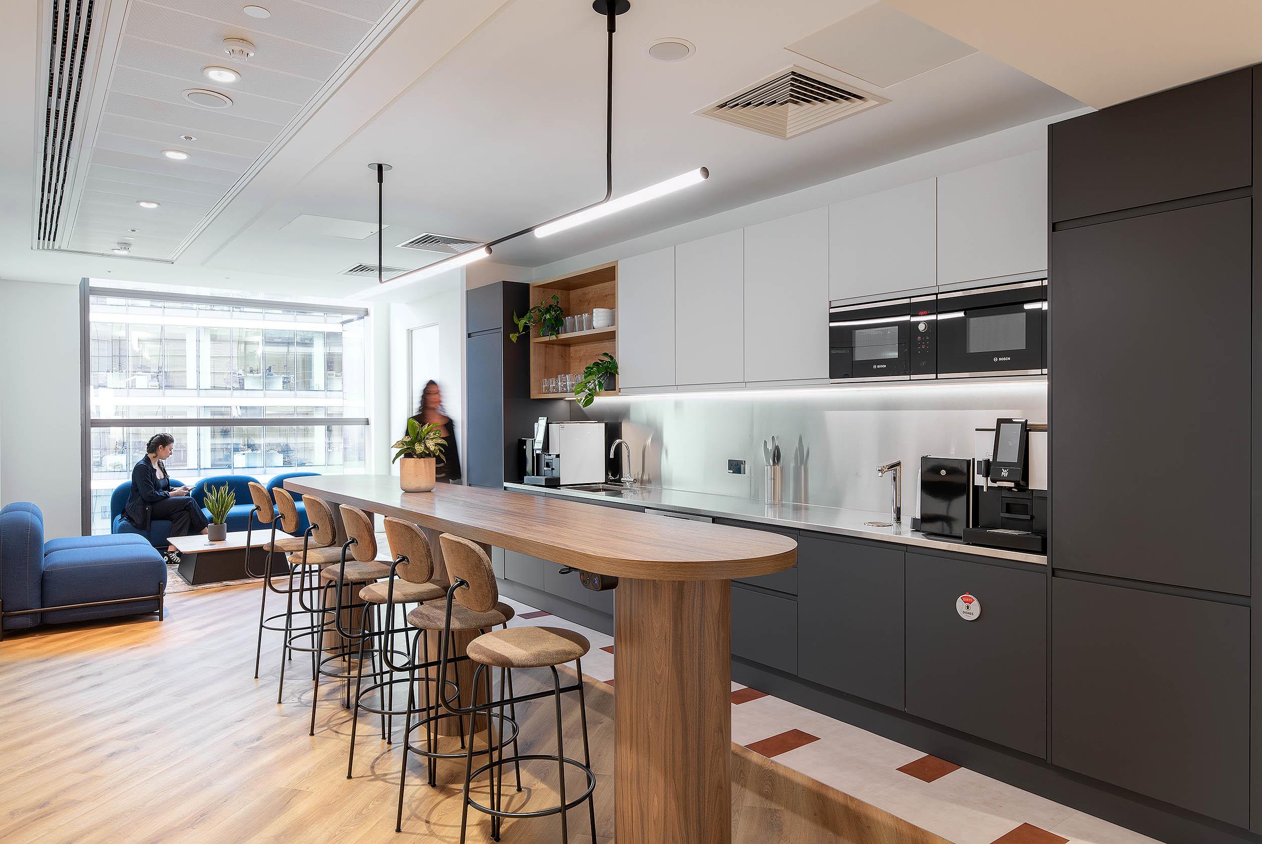 Teapoint at AMC with high table, upholstered stools and soft seating supplied by Platfform, designed for casual collaboration and coffee breaks.