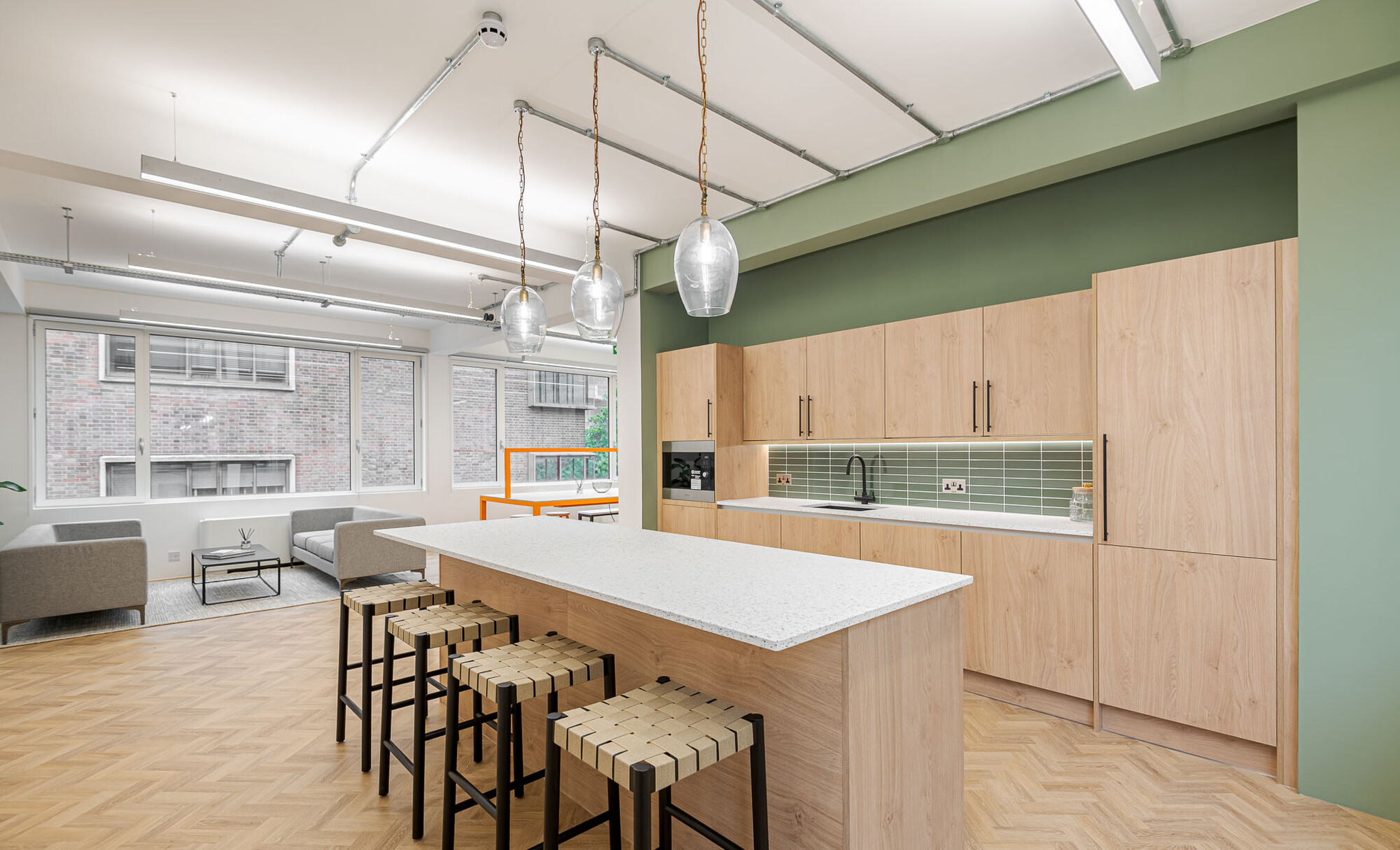 Chic office kitchen on Berry Street designed by Platfform, equipped with modern bar stools and a stylish wooden kitchenette.