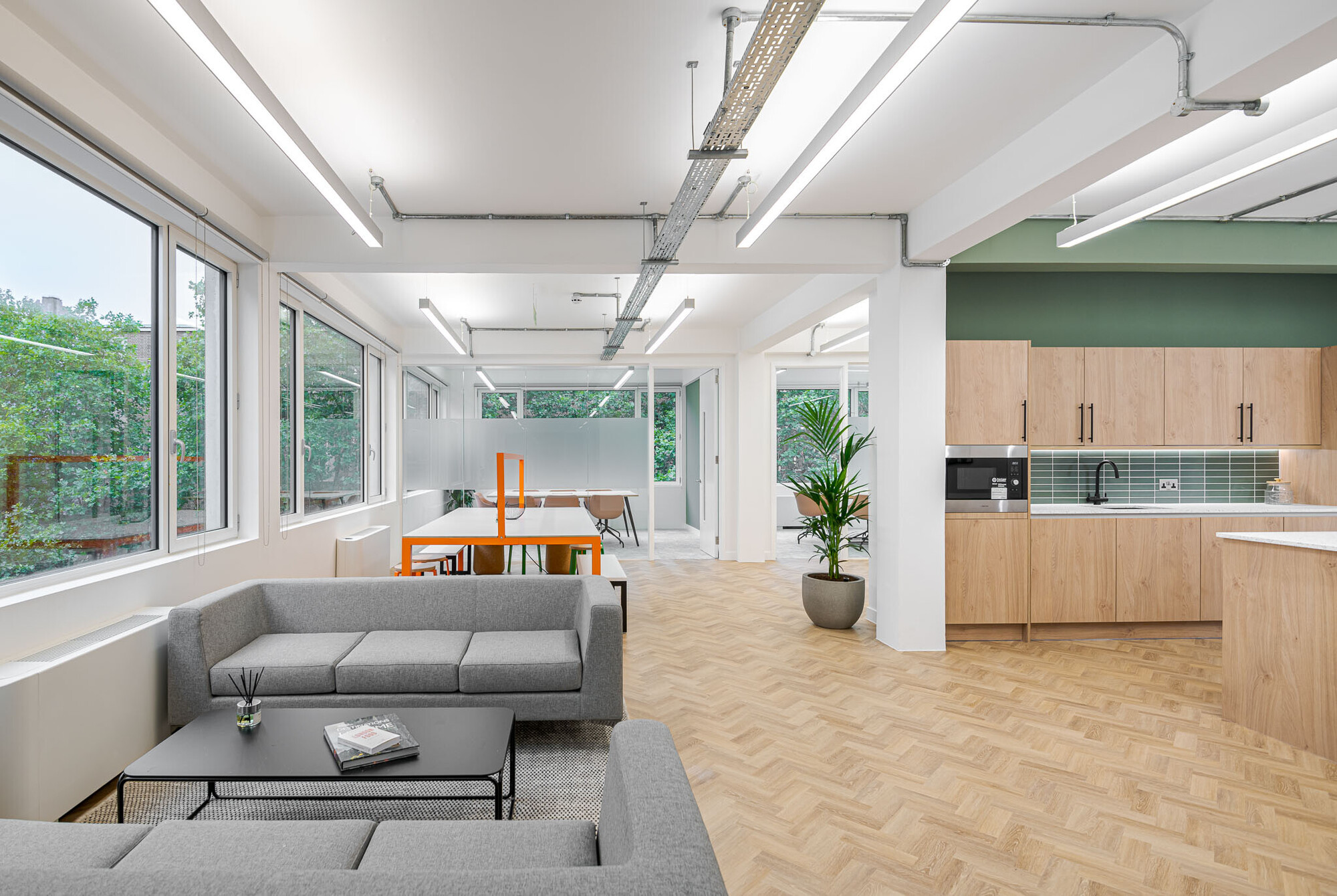 Spacious office lounge at Berry Street designed by Platfform, integrating relaxed seating areas with modern décor and ample lighting.