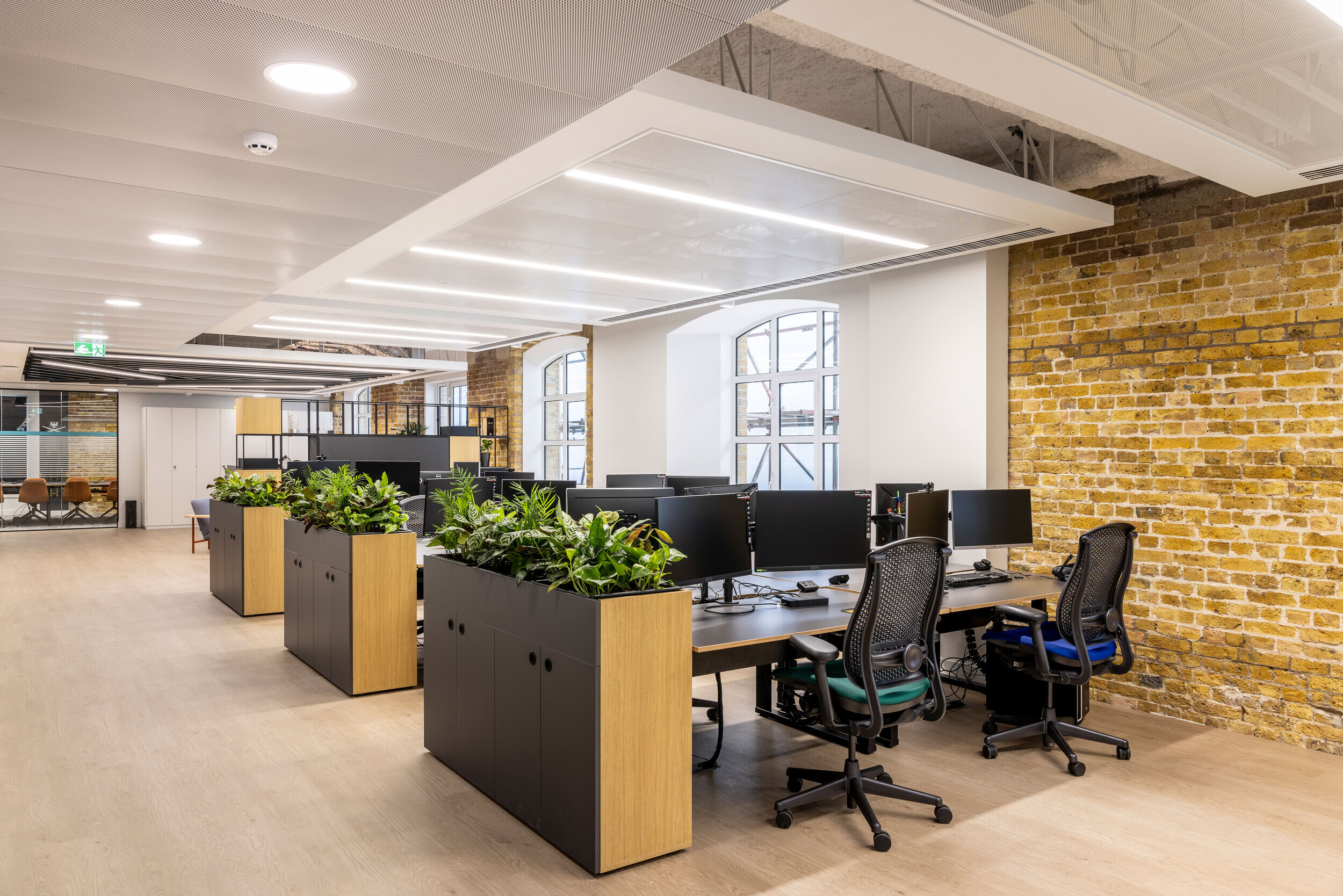 Collaborative open-plan workspace with furniture by Platfform. Featuring integrated biophilia and flexible desk arrangements for productivity.