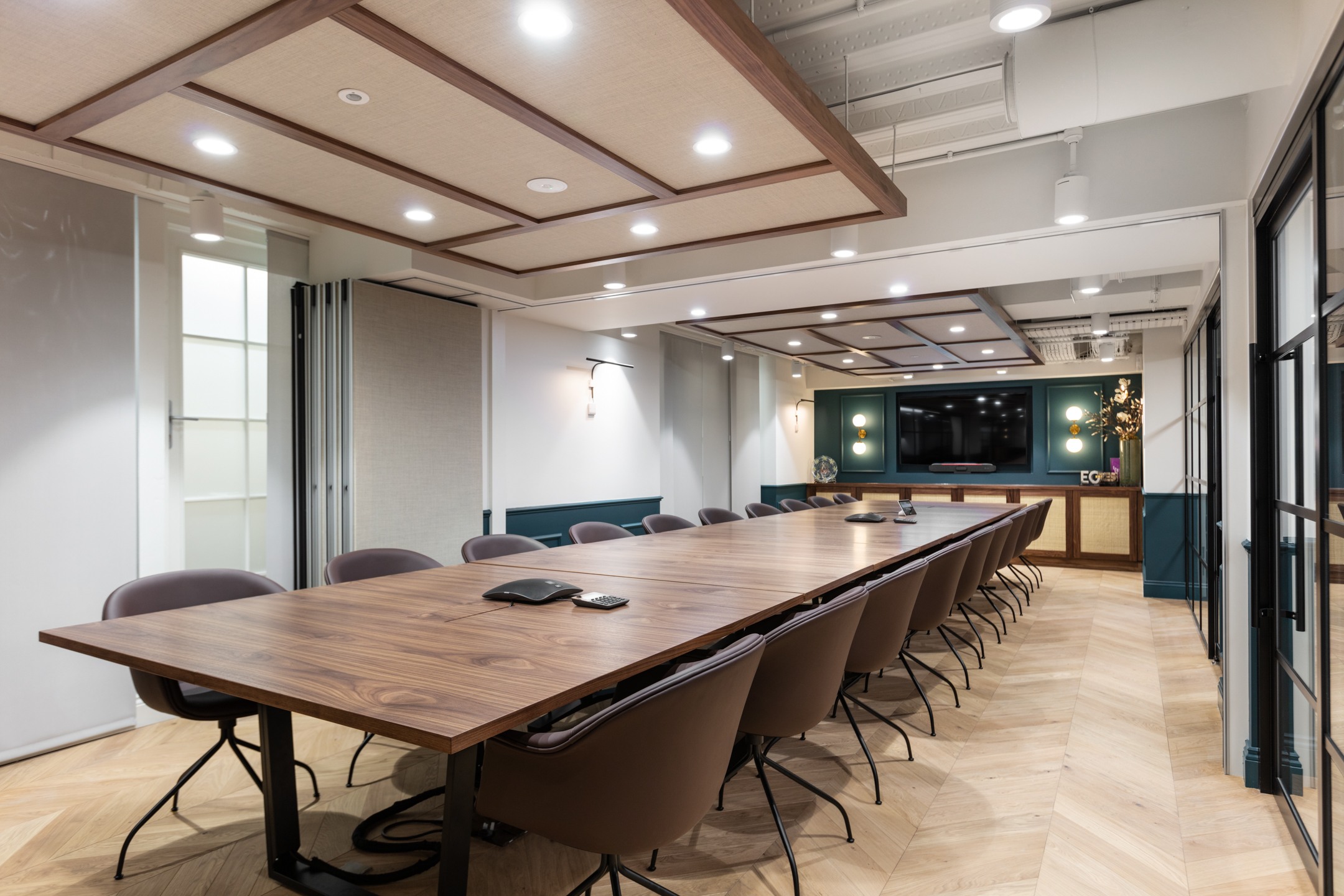 Large boardroom for Cain International with a walnut meeting table and sleek brown chairs, all furniture specified by Platfform to support high-level collaboration.