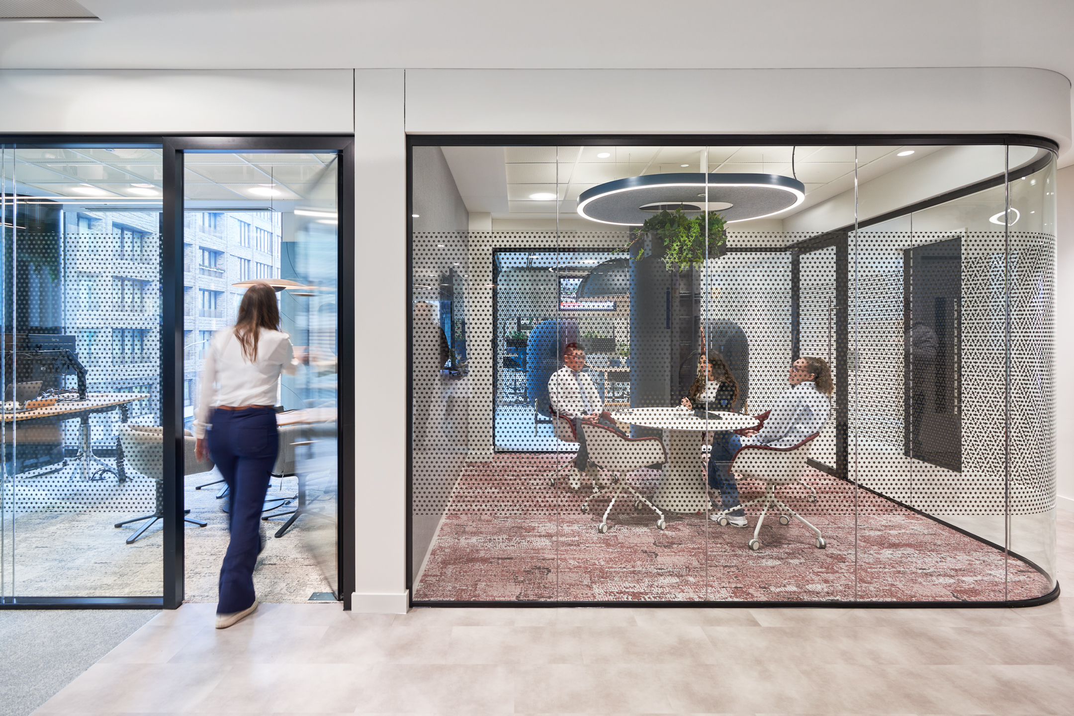 Glazed meeting room at capital.com with perforated detail, ergonomic meeting chairs and circular table furniture supplied by Platfform.