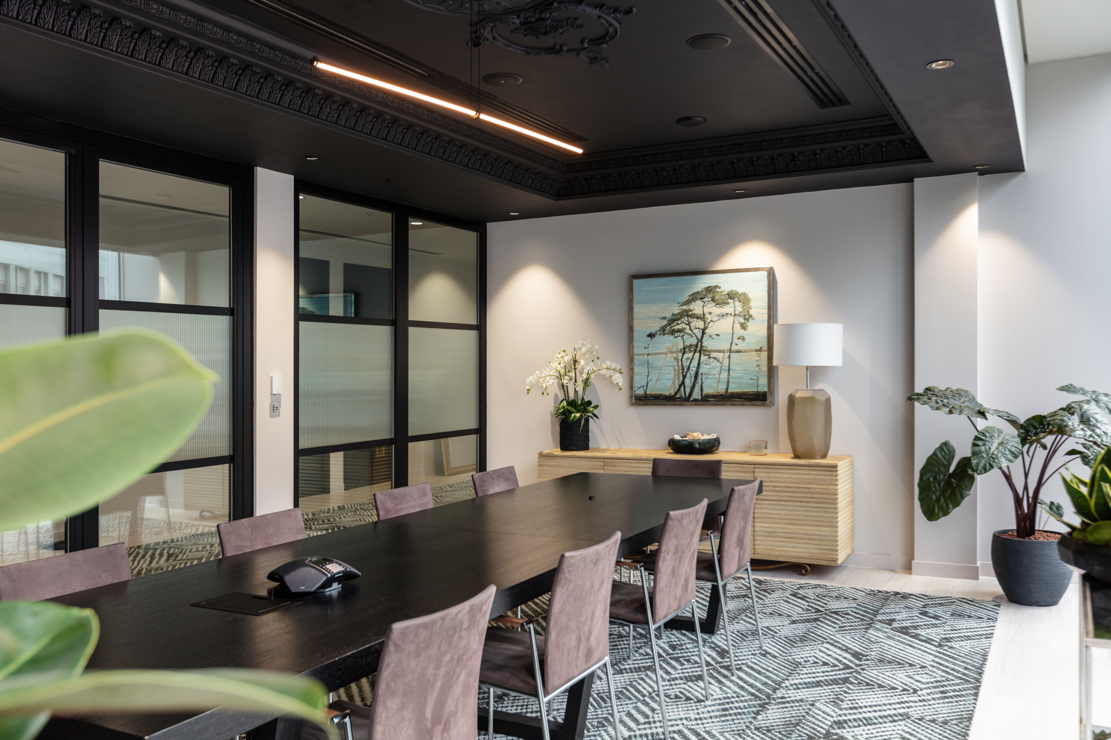 finnCap boardroom with furniture by Platfform, featuring a long meeting table, upholstered chairs and a statement sideboard styled with artwork and planting.