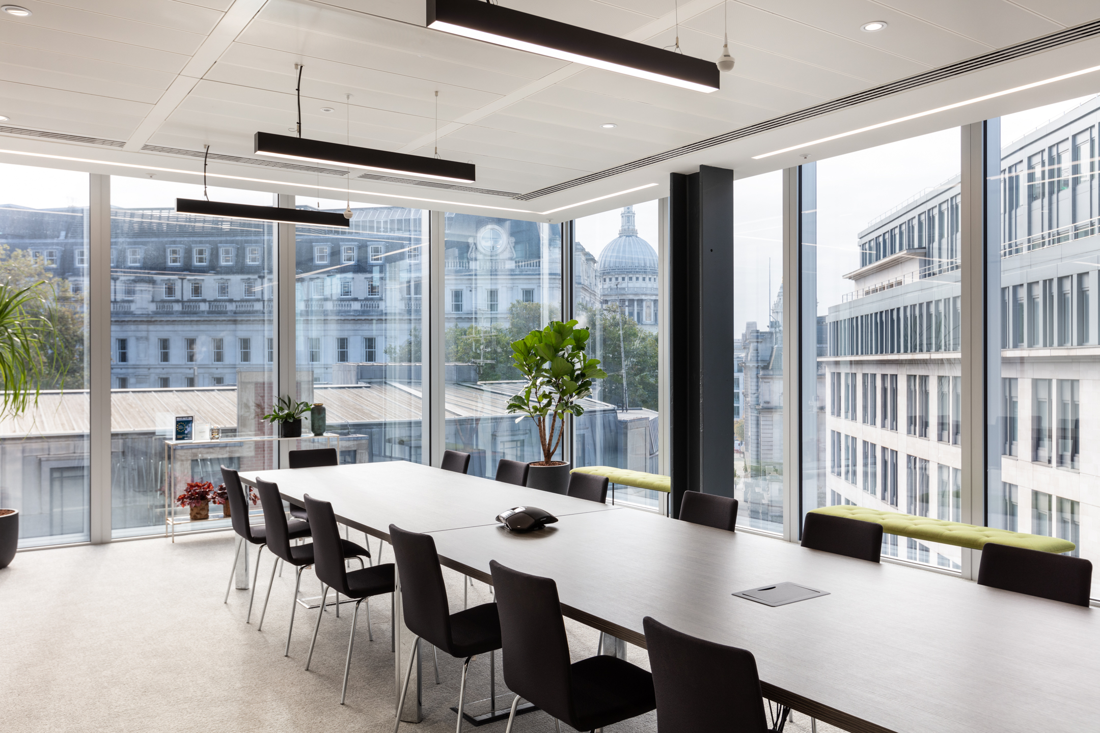 finnCap meeting space with panoramic city views, furnished by Platfform with a light-toned table and black chairs in a modern glazed setting.