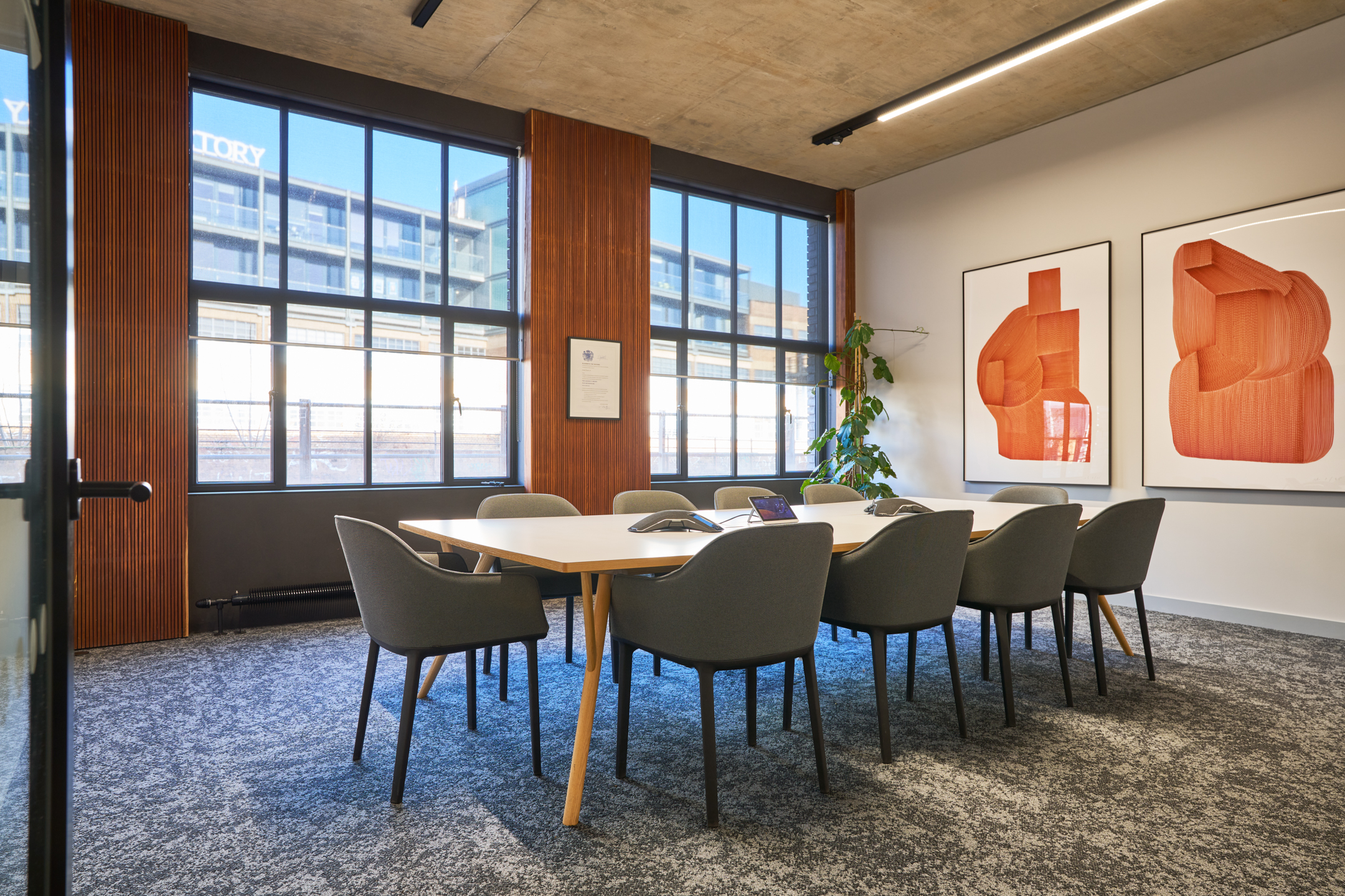 Private meeting room in the Joseph Joseph office featuring bold artwork, sleek furniture, and large windows.