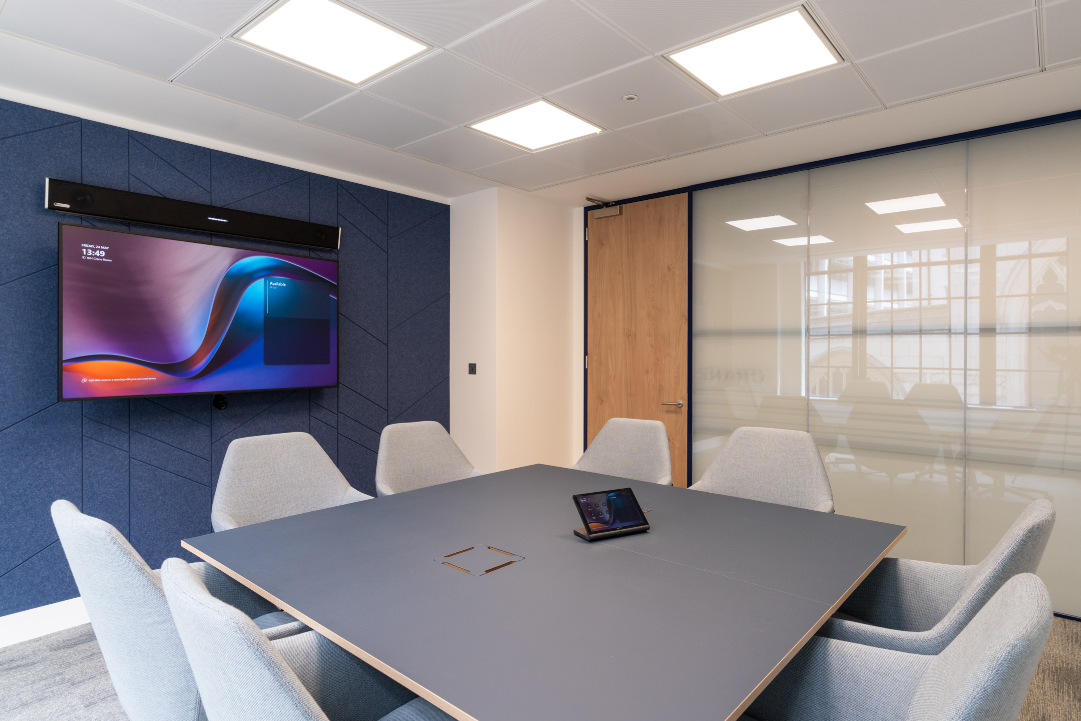 Modern meeting room at the Port of London Authority office by Platfform, featuring a sleek table, integrated technology, and acoustic panelled walls.