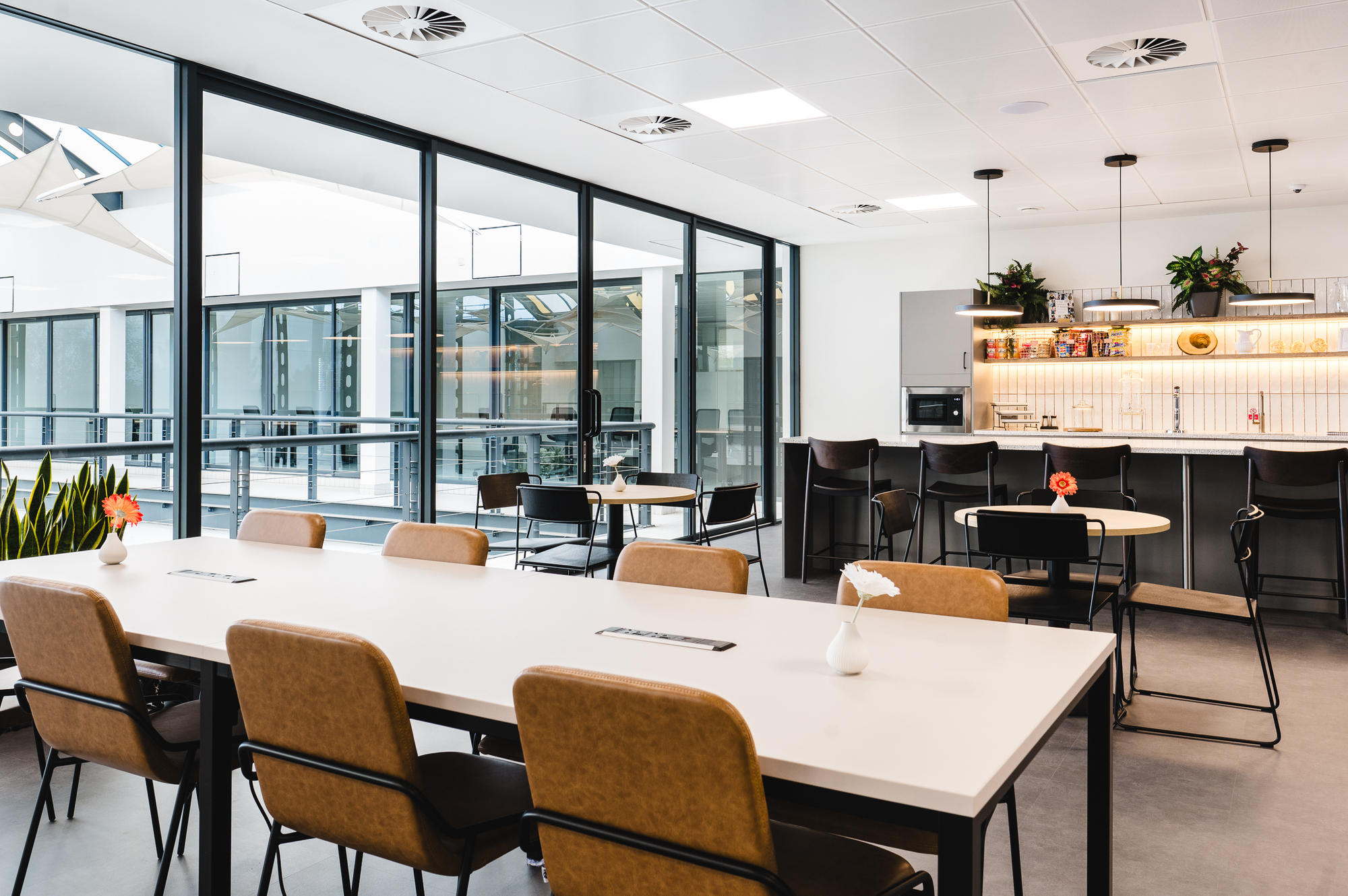 Open-plan seating and kitchen area in the Serendipity Labs Bristol coworking space, furniture by Platfform for NewFlex.