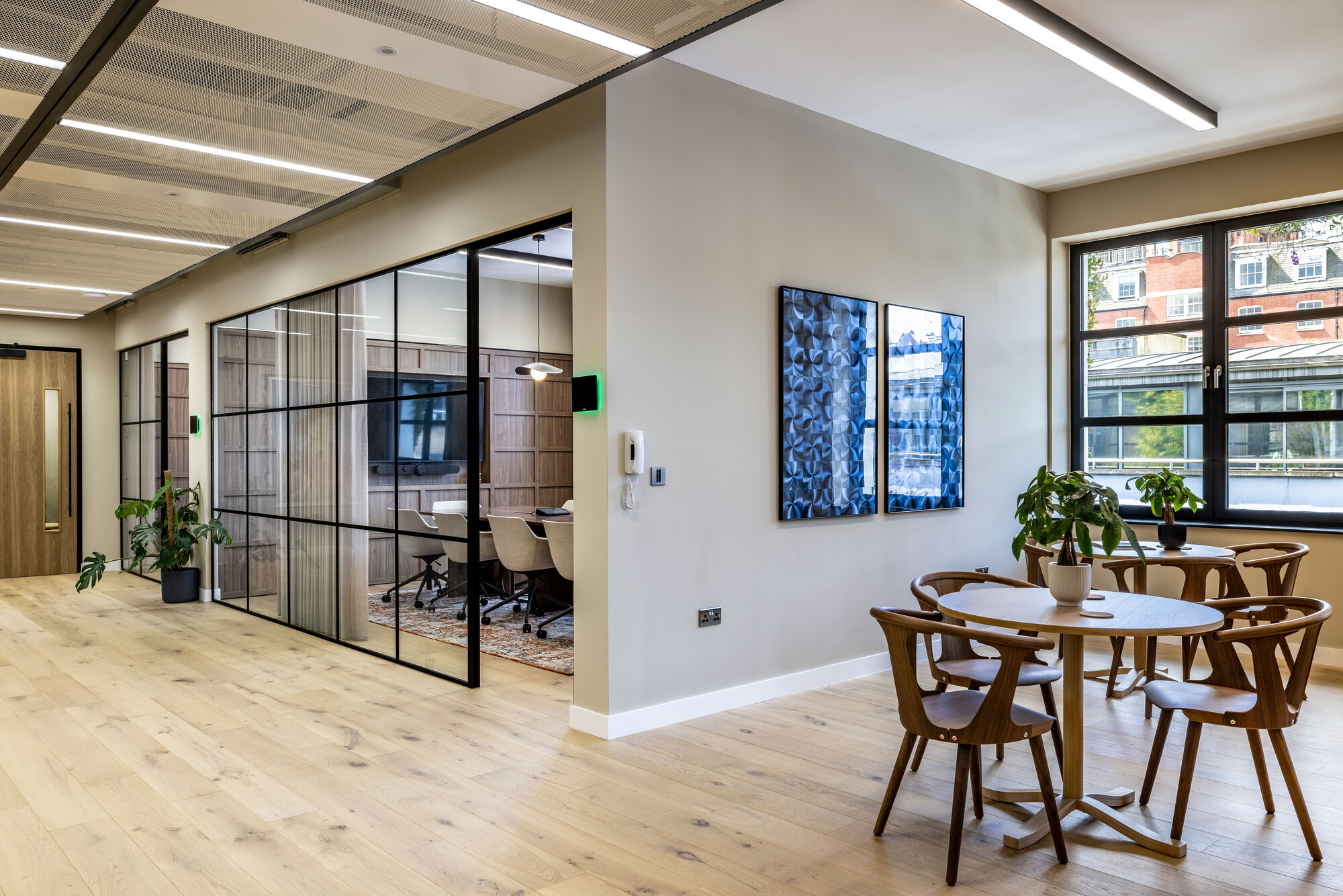 Open-plan workspace at Transition's London office by Platfform, combining glass partitions with natural wood finishes for a modern and sustainable design.
