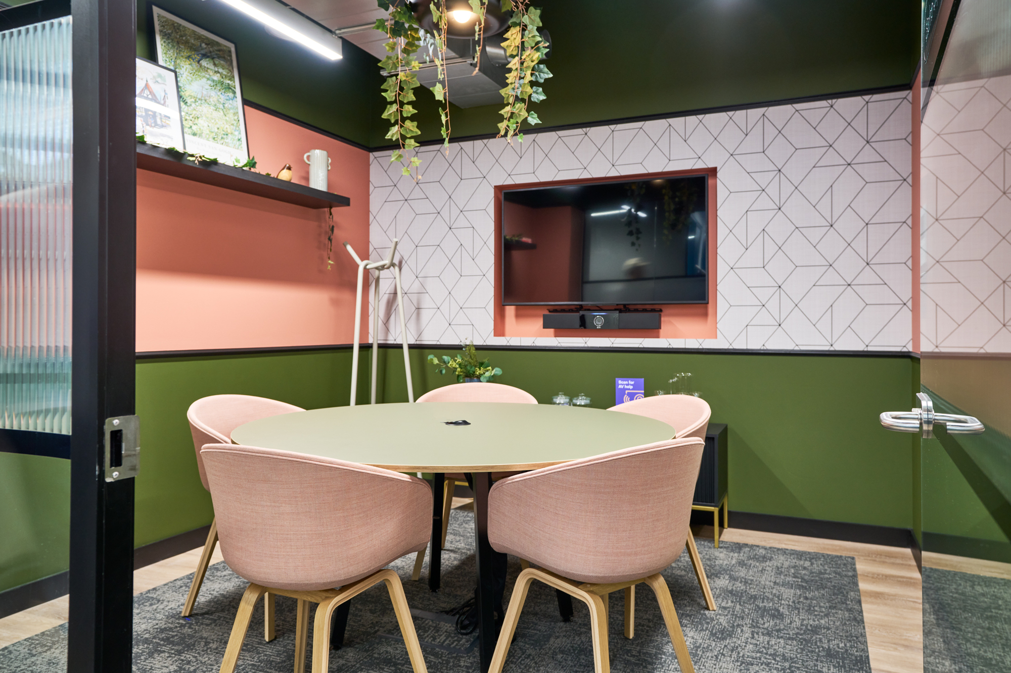 Intimate meeting room at Work.Life Waverly House designed by Platfform, with earthy tones, pink seating, and geometric wall patterns for a creative atmosphere.