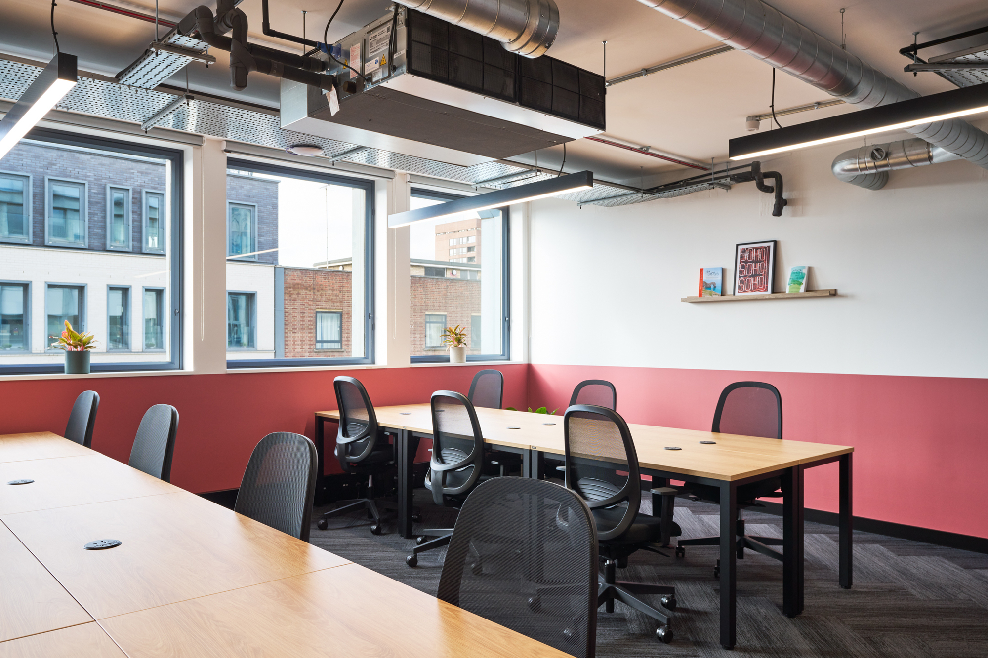 Bright workspace at Work.Life Waverly House designed by Platfform, featuring modern desks, ergonomic chairs, and Soho-inspired decor against a warm colour palette.