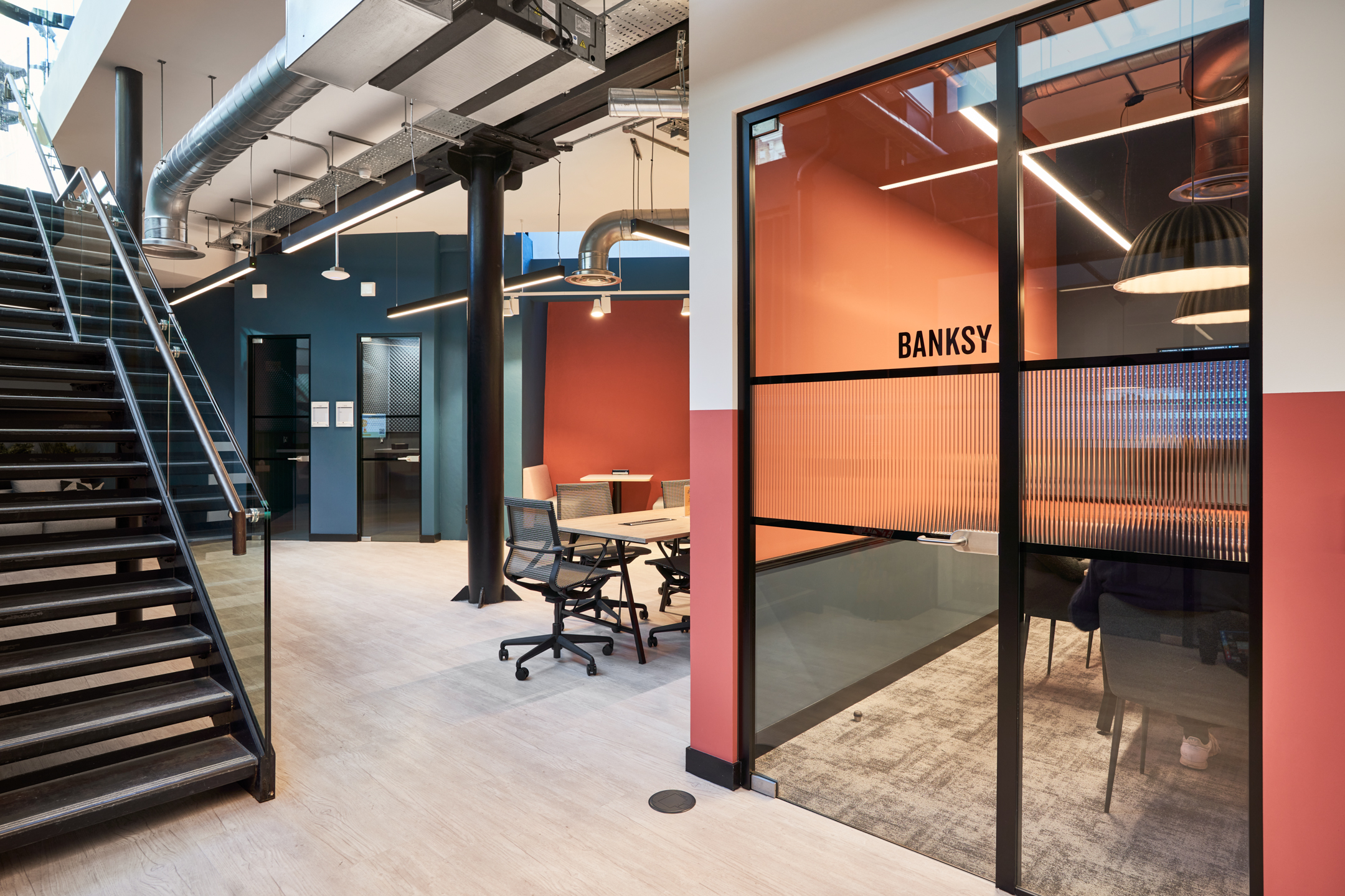 Open workspace and meeting rooms at Work.life Rivington House, designed by Platfform, with bold colour accents and modern furnishings creating a dynamic and productive environment.