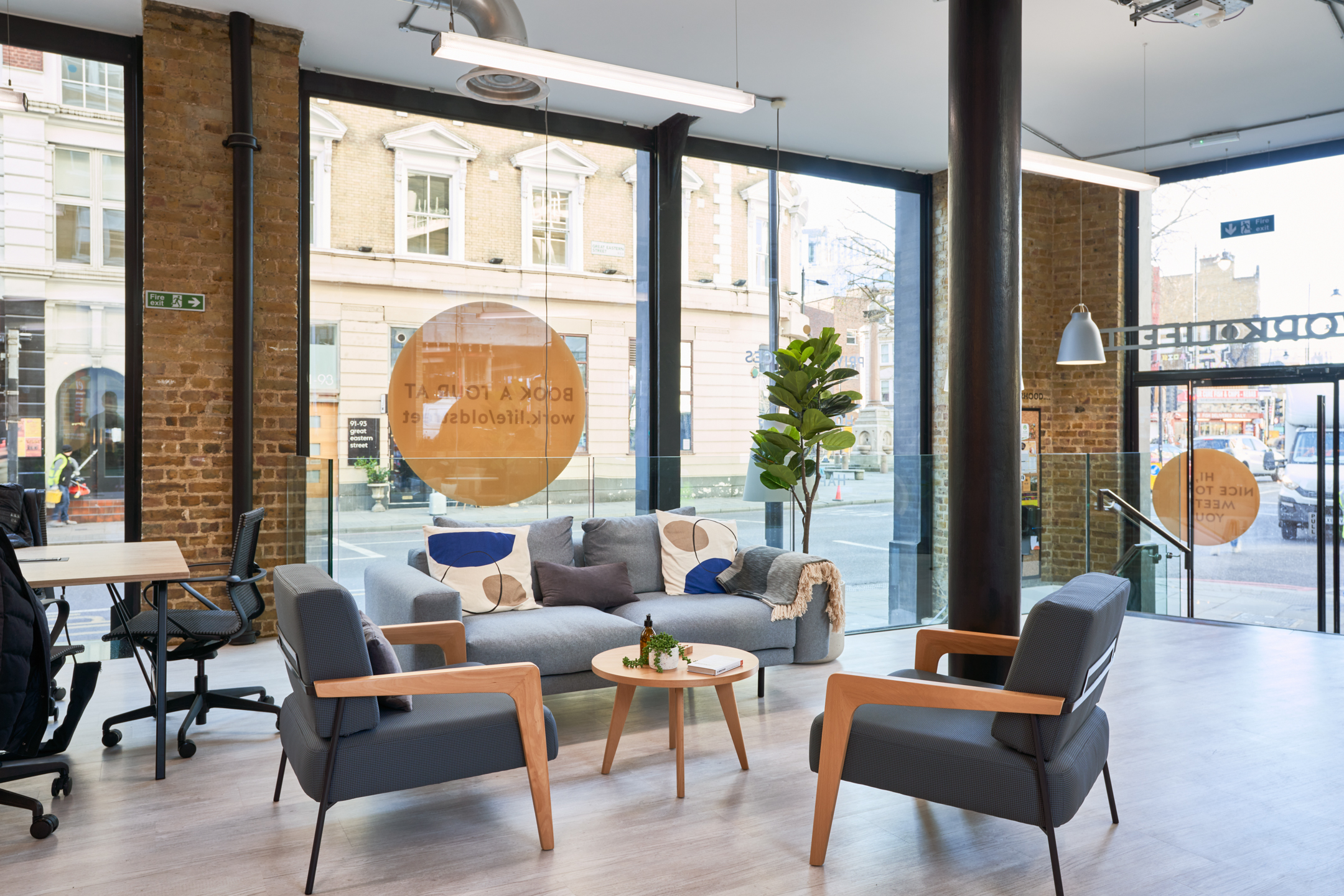 A welcoming lounge area at Work.life Rivington House by Platfform, with modern furniture and large windows allowing natural light to enhance the inviting workspace.