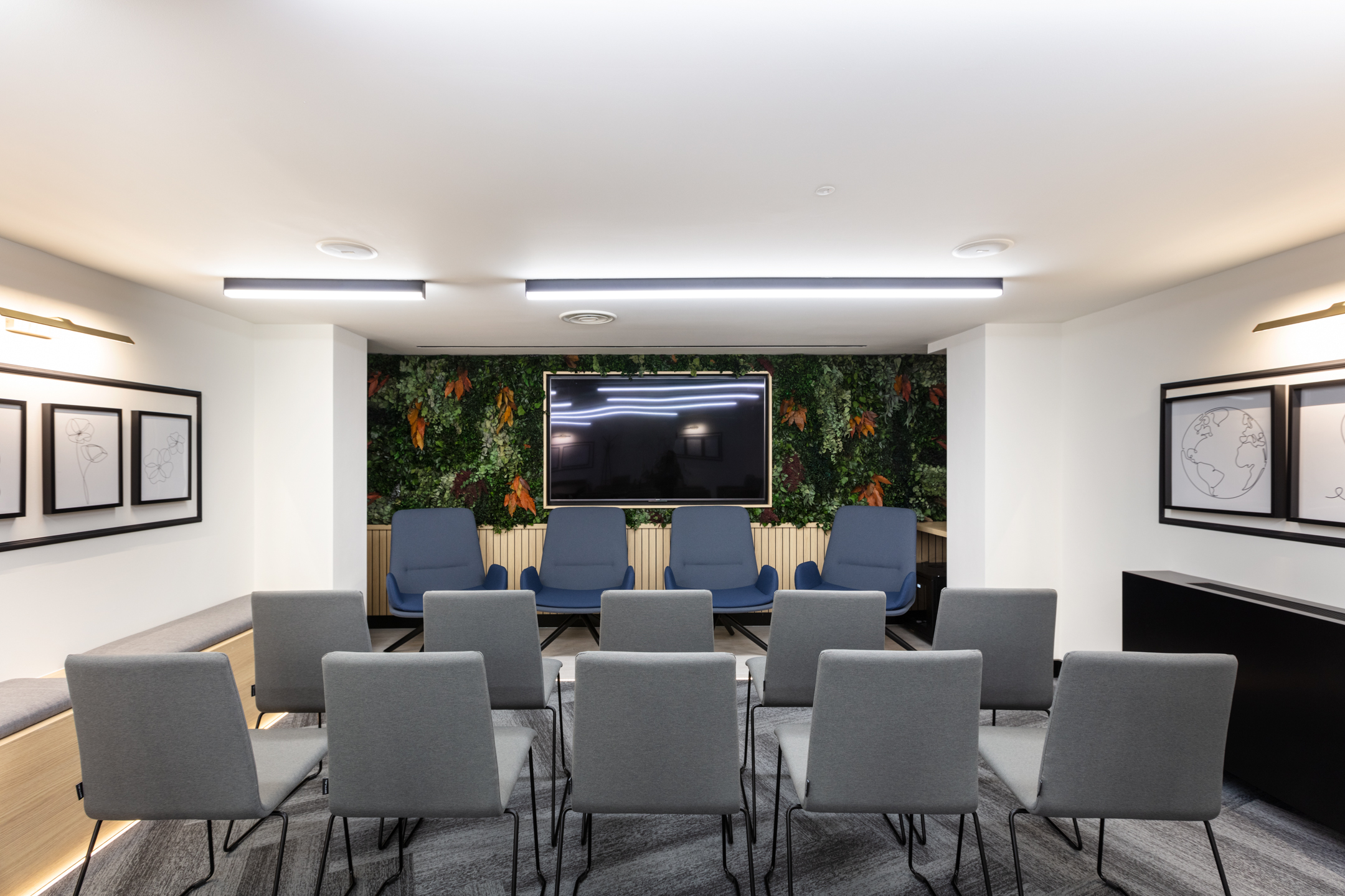 A professional meeting space in Work.life Red Lion Street with contemporary chairs and a lush green feature wall, showcasing Platfform's innovative approach to creating workspaces.