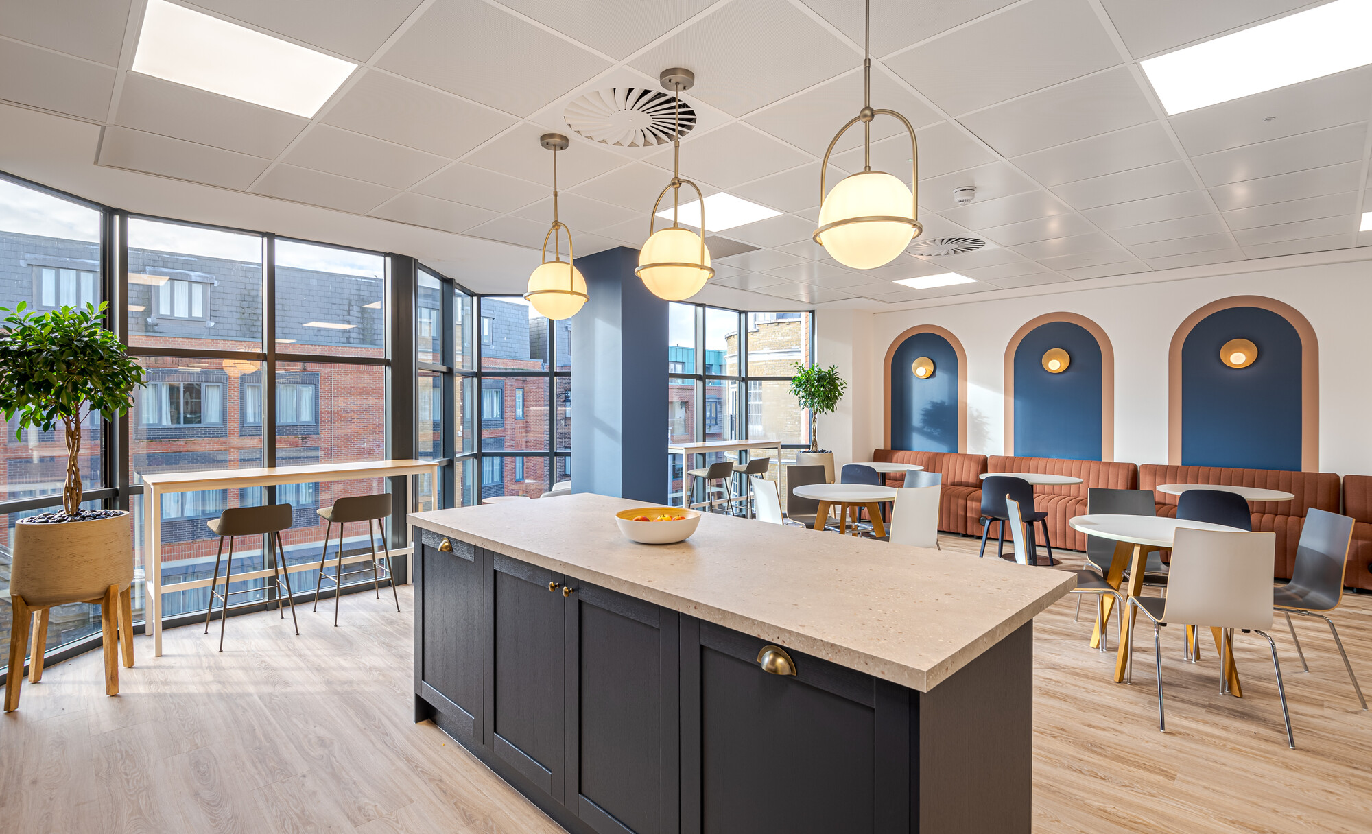 Accelya’s teapoint with a central island, globe pendant lighting and layered seating, furnished by Platfform to echo inflight lounge charm.
