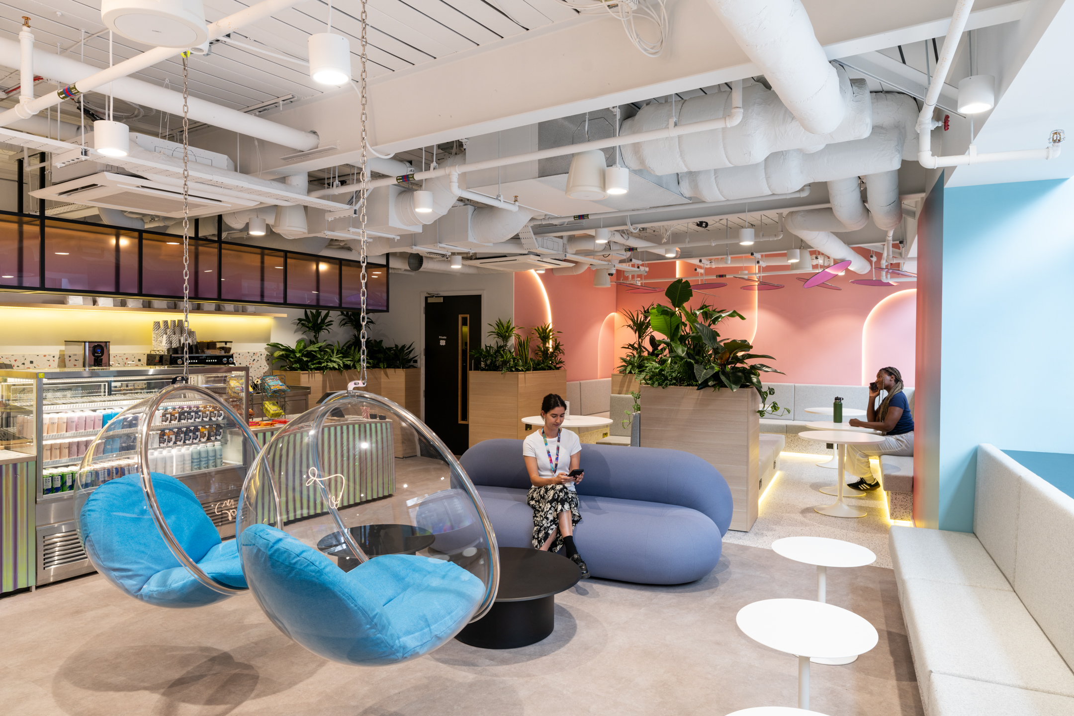Furniture installation at Huckletree, Bishopsgate, showing a colourful breakout area with playful bubble chairs, a curved sofa, and integrated planting.