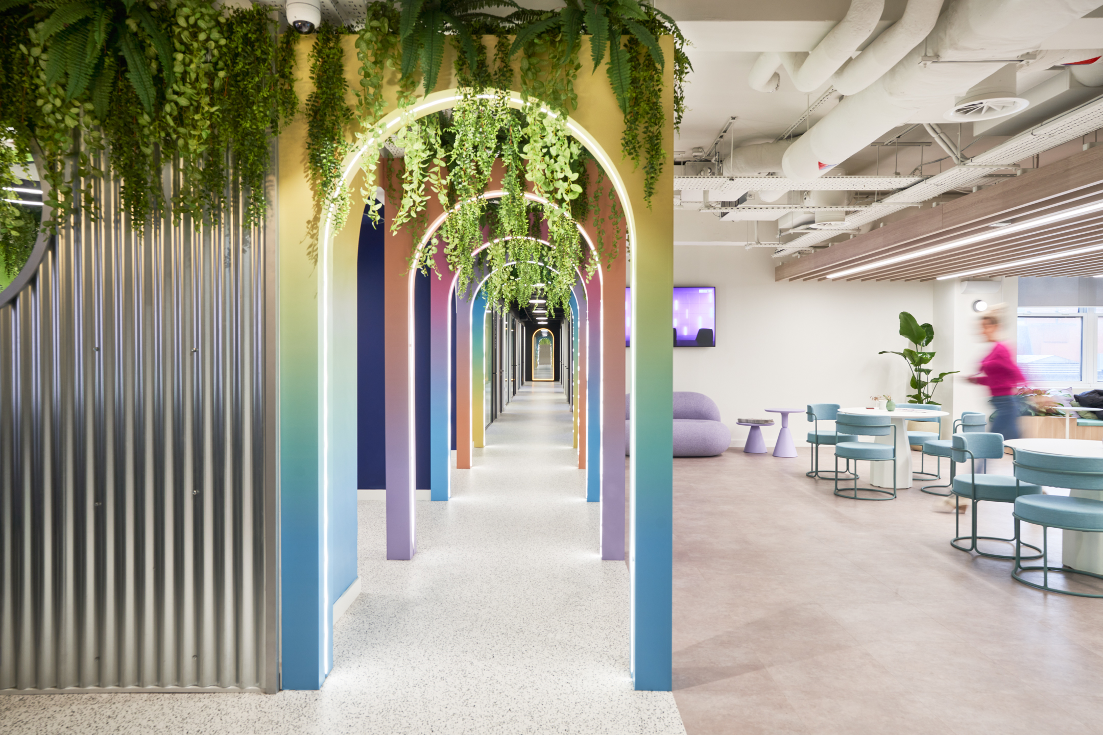 Colourful arched walkway and soft seating area at Huckletree Oxford Street, with furniture supplied by Platfform to match the bold, playful interior.