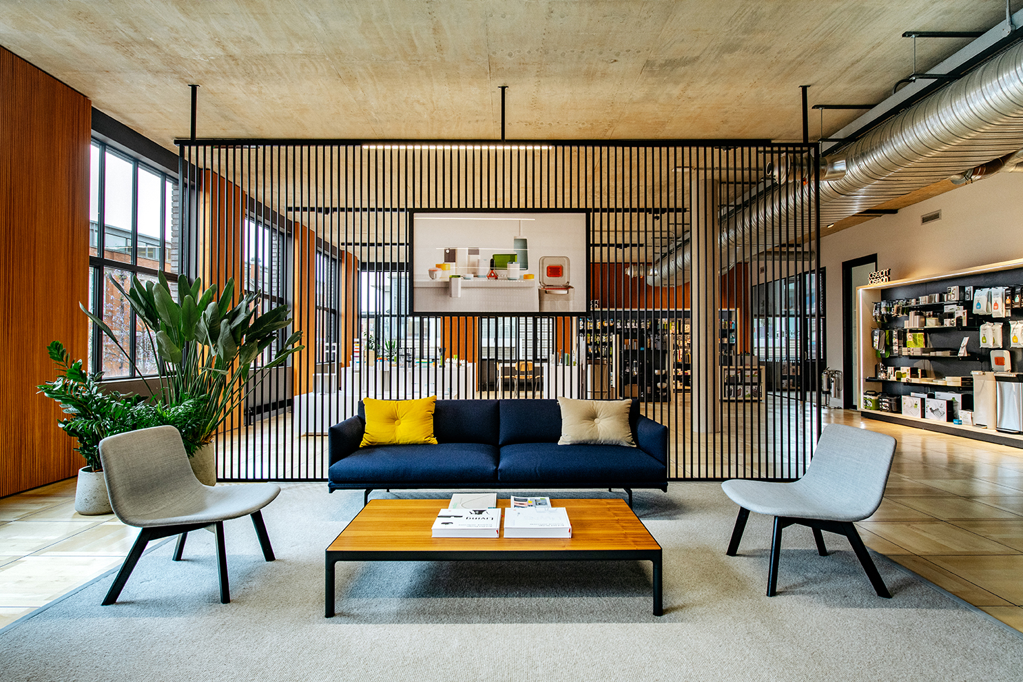 Reception waiting area at the Joseph Joseph office, featuring modern lounge furniture and a slatted timber screen backdrop.