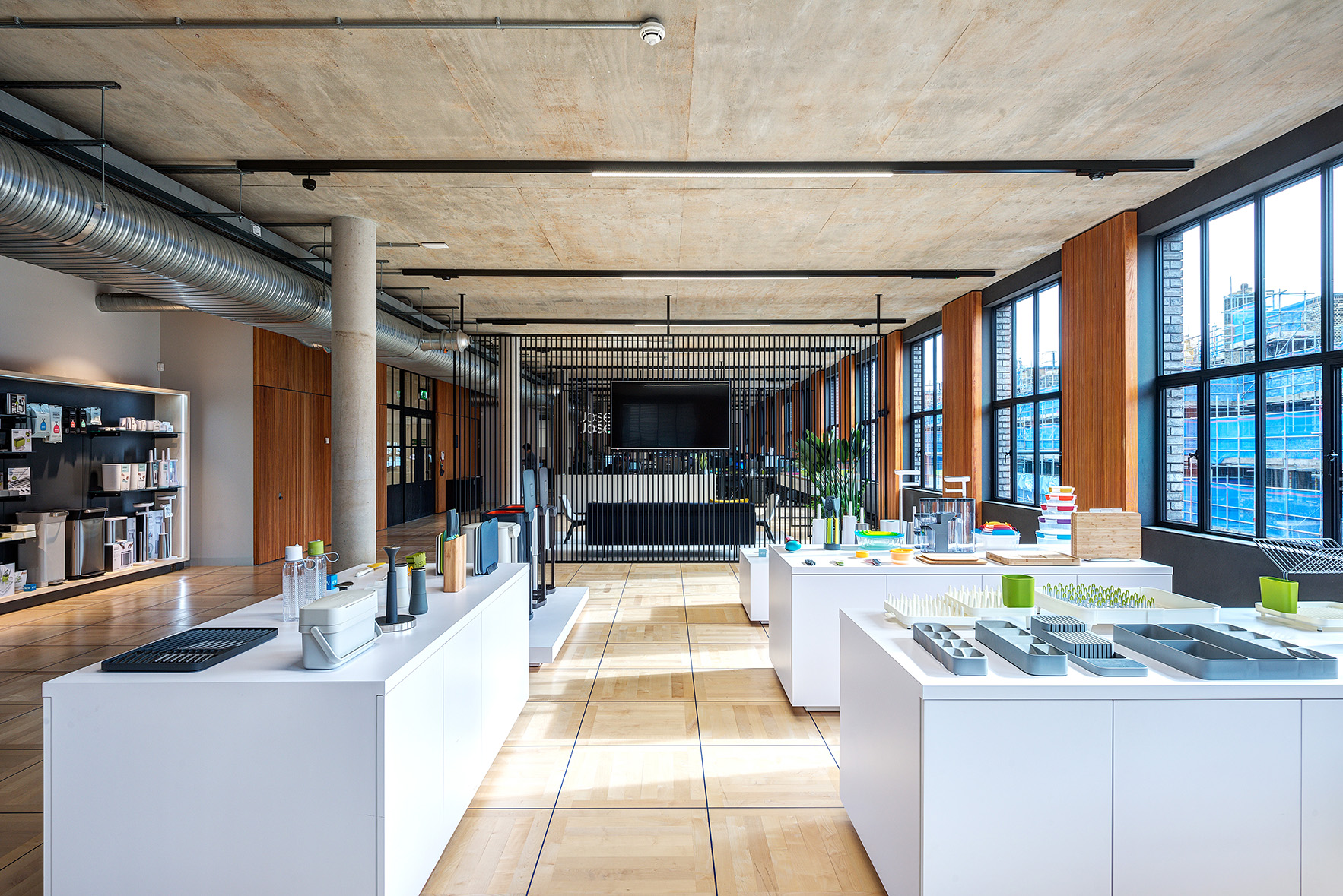Joseph Joseph reception showroom with display islands presenting their signature kitchenware, set within a bright, industrial-style interior.
