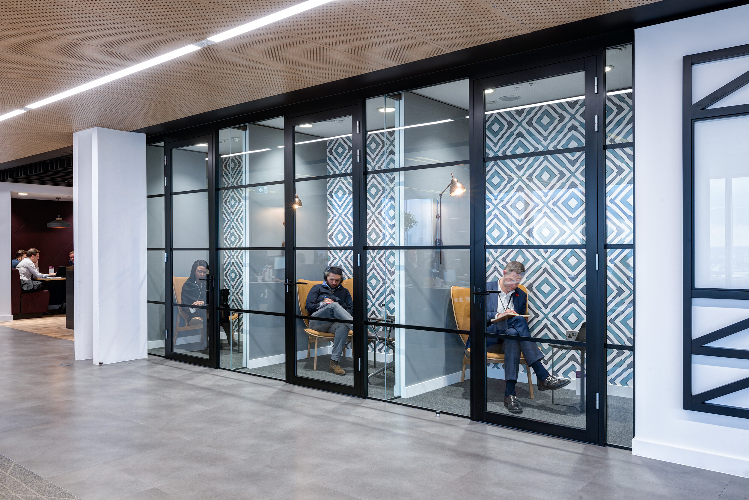 Private focus rooms at MITIE's Shard office, each fitted with contemporary armchairs and lamps selected by Platfform.