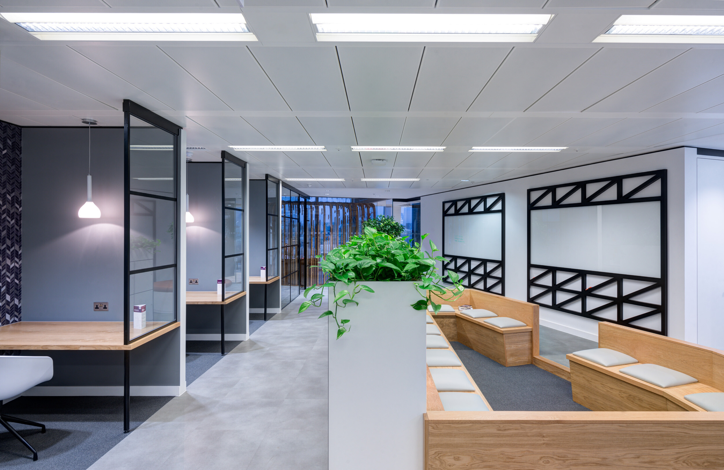 Quiet workstations and bleacher-style seating at MITIE's Shard office, furnished by Platfform to balance privacy with informal collaboration.