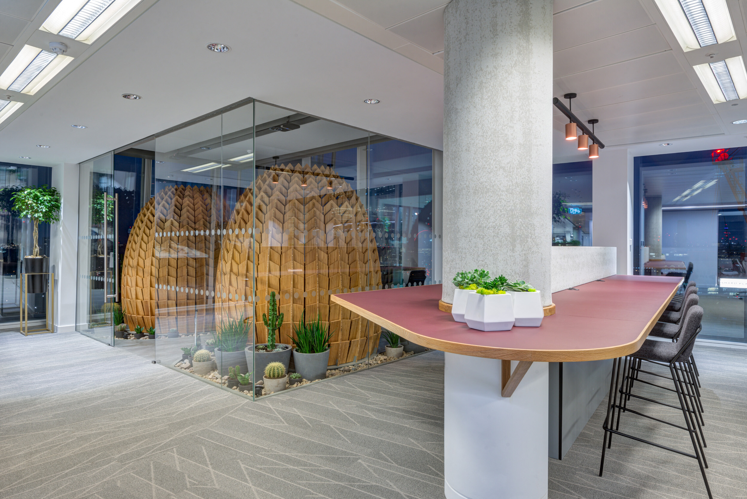 MITIE's Shard office featuring a sculptural timber pod, cactus garden, and high counter seating installed by Platfform for dynamic workspace use.