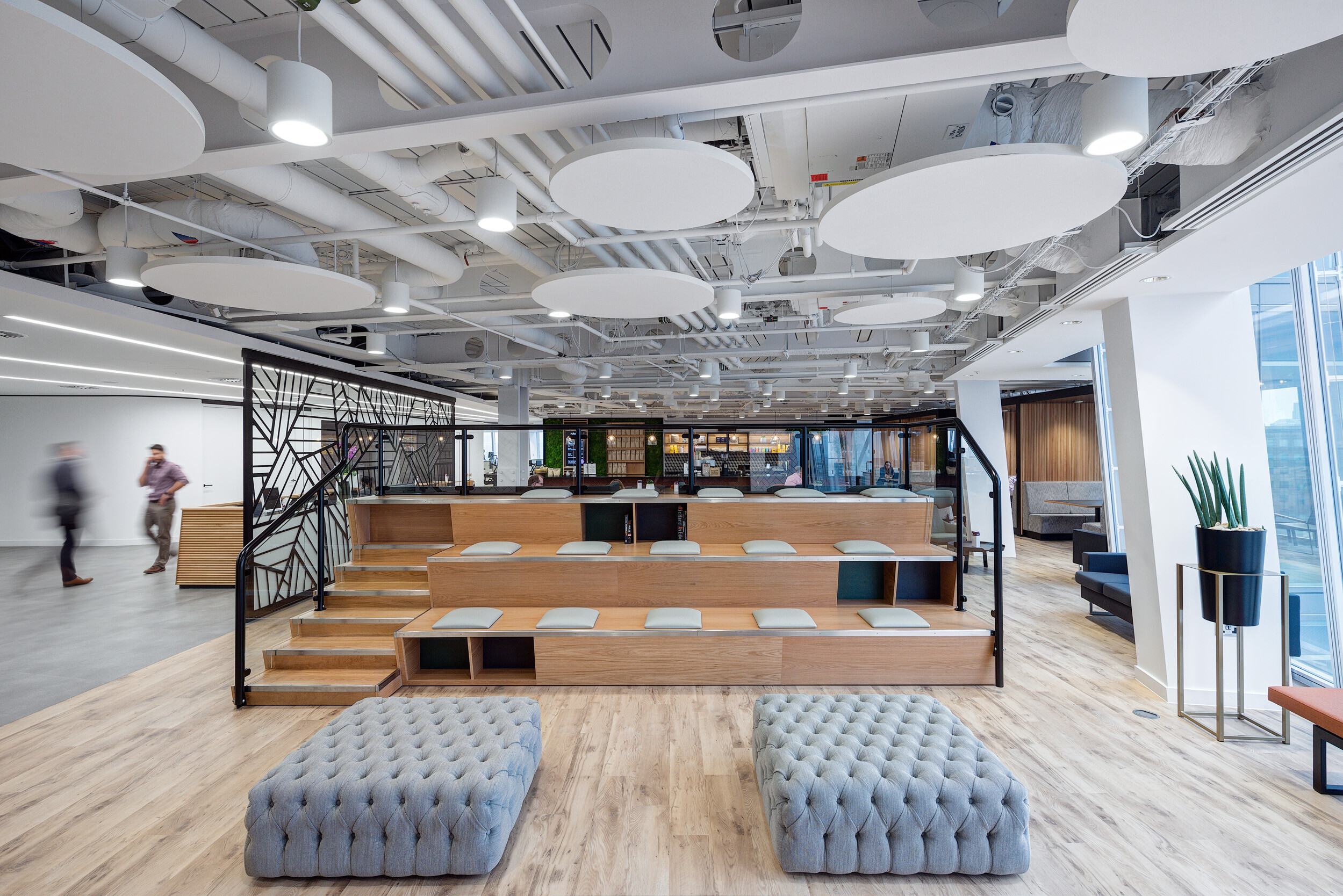 Tiered seating with integrated storage and soft upholstered ottomans at MITIE's Shard office, furnished and styled by Platfform.