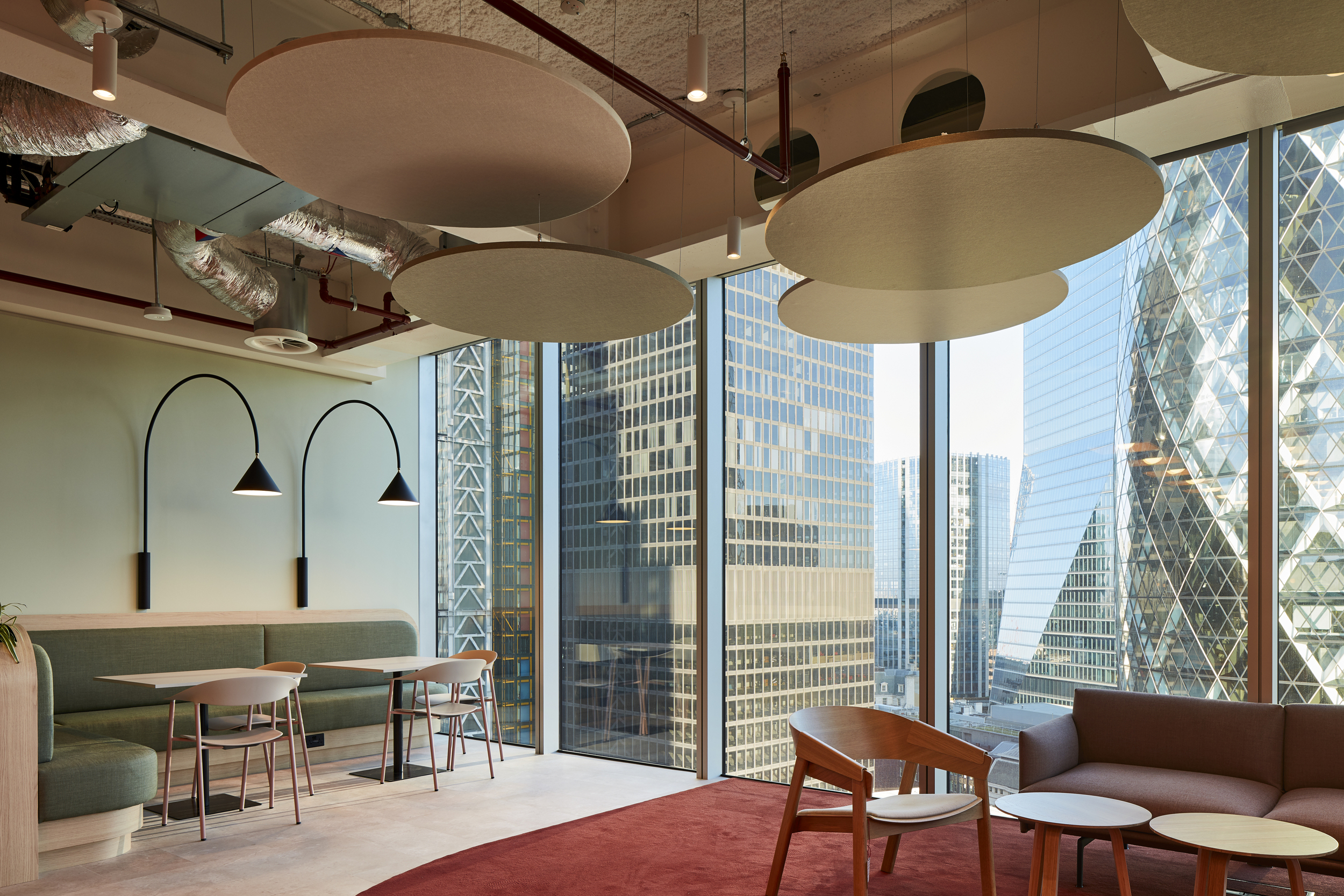 McGill & Partners workspace with Platfform-supplied banquette seating, café-style tables, and lounge furniture framed by full-height city views.