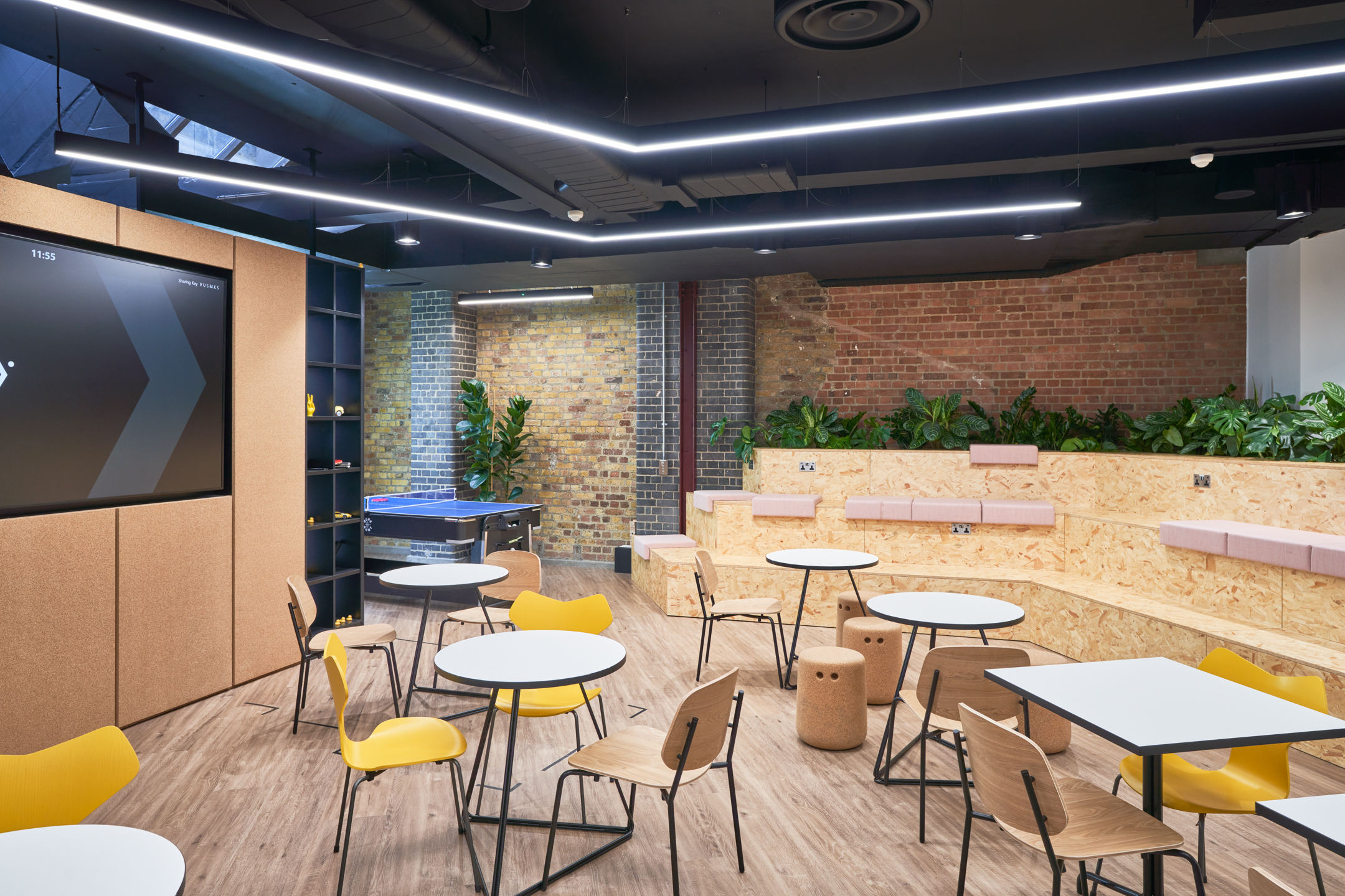 Social and breakout space at Motorway’s office with tiered seating, playful furniture and greenery, all supplied by Platfform as the furniture consultant.