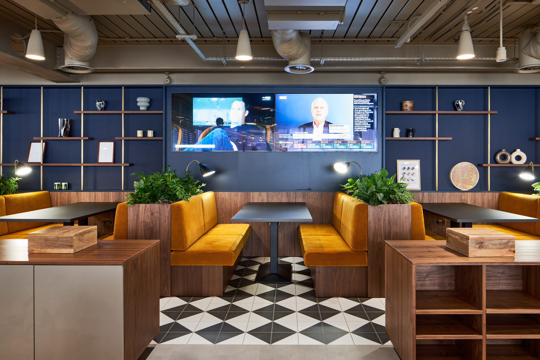 Informal booth seating with mustard upholstery and integrated planters at Private Equity Fund, combining comfort with a sleek, hospitality-inspired design.