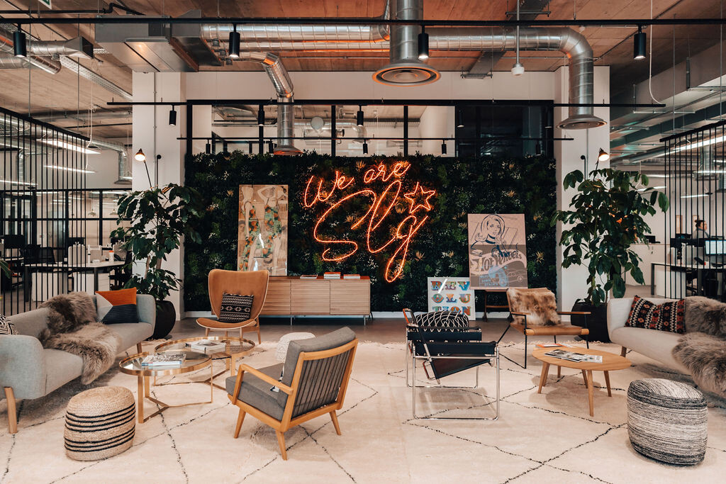 SLG reception space in Cheltenham furnished with layered textures, soft seating and statement pieces designed to reflect the brand’s bold identity.