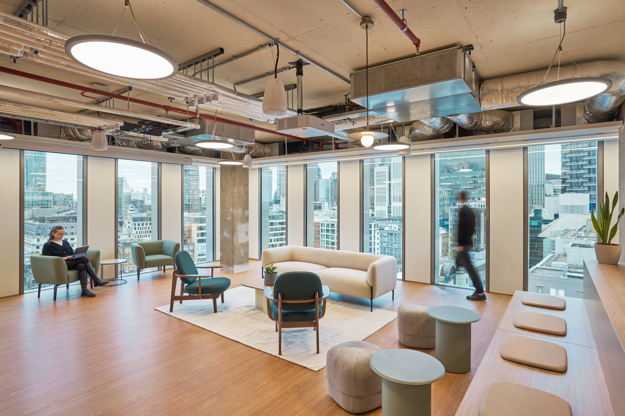 Salesloft breakout lounge with soft seating, warm timber flooring and panoramic views across London, furnished by Platfform.