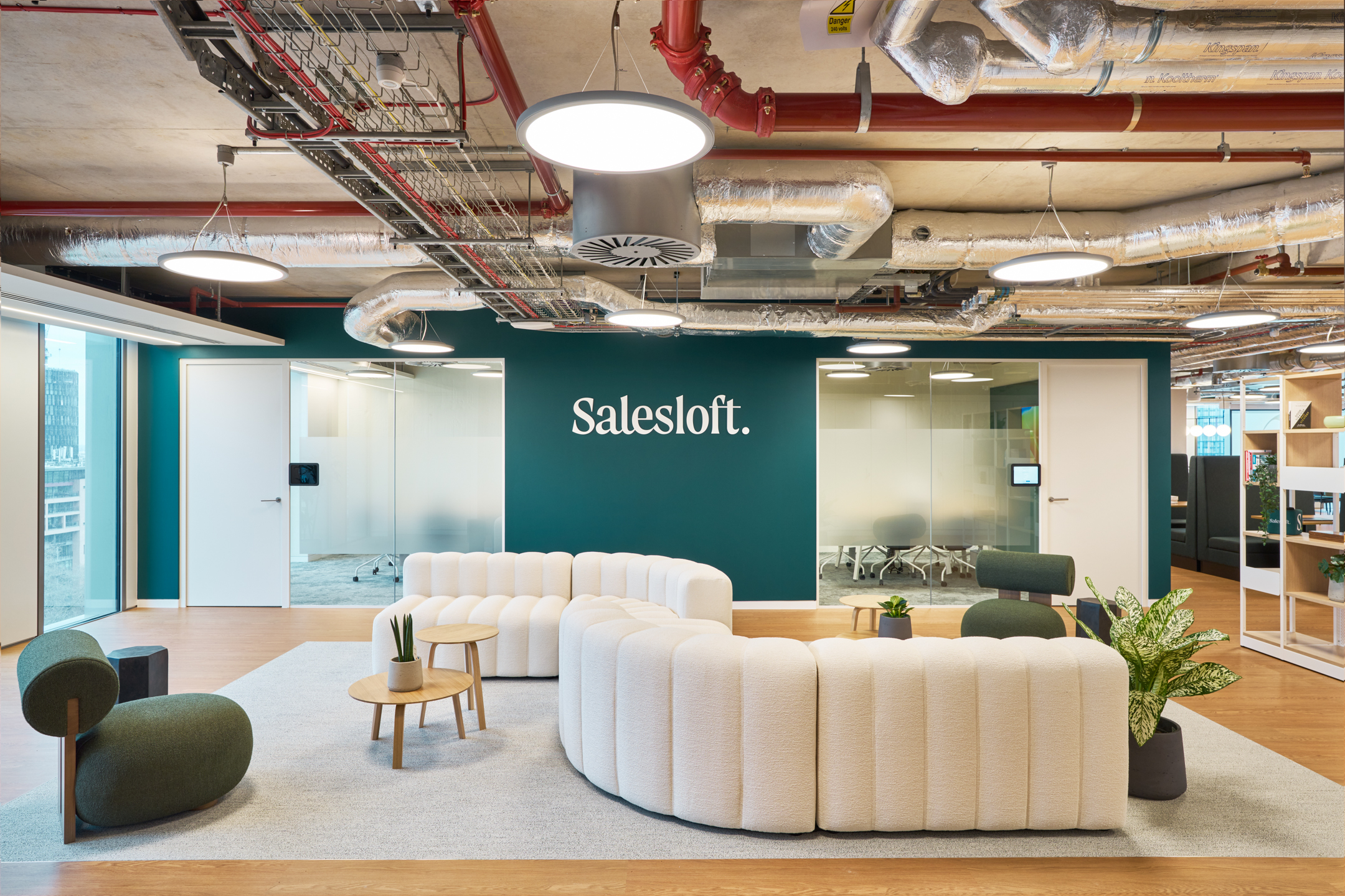 Salesloft reception with cream boucle sofas and sculptural lounge chairs, furnished by Platfform to create a welcoming first impression.
