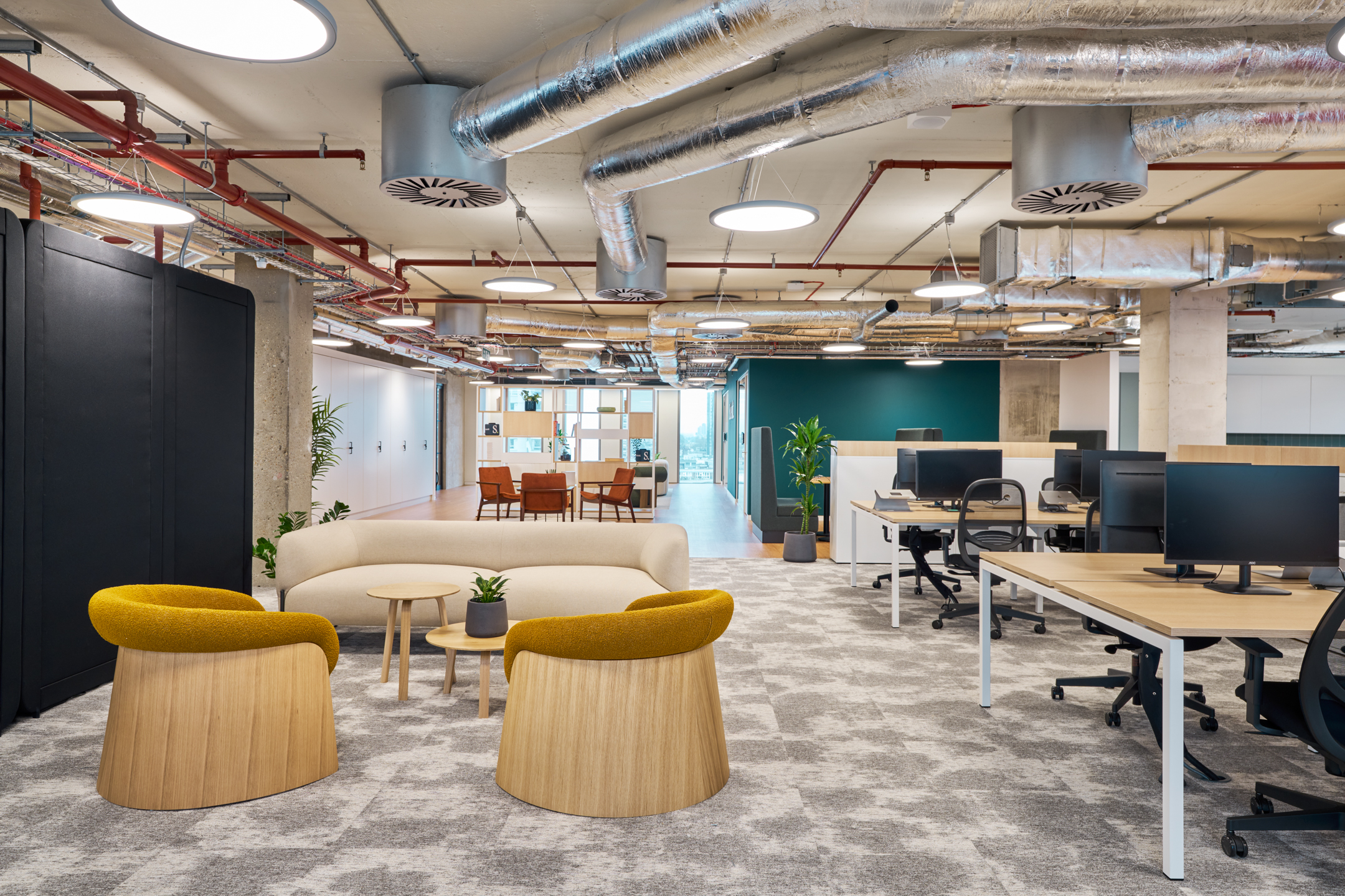 Salesloft open-plan workspace with soft lounge seating, mustard armchairs and bench desking, all furnished by Platfform to support agile working.
