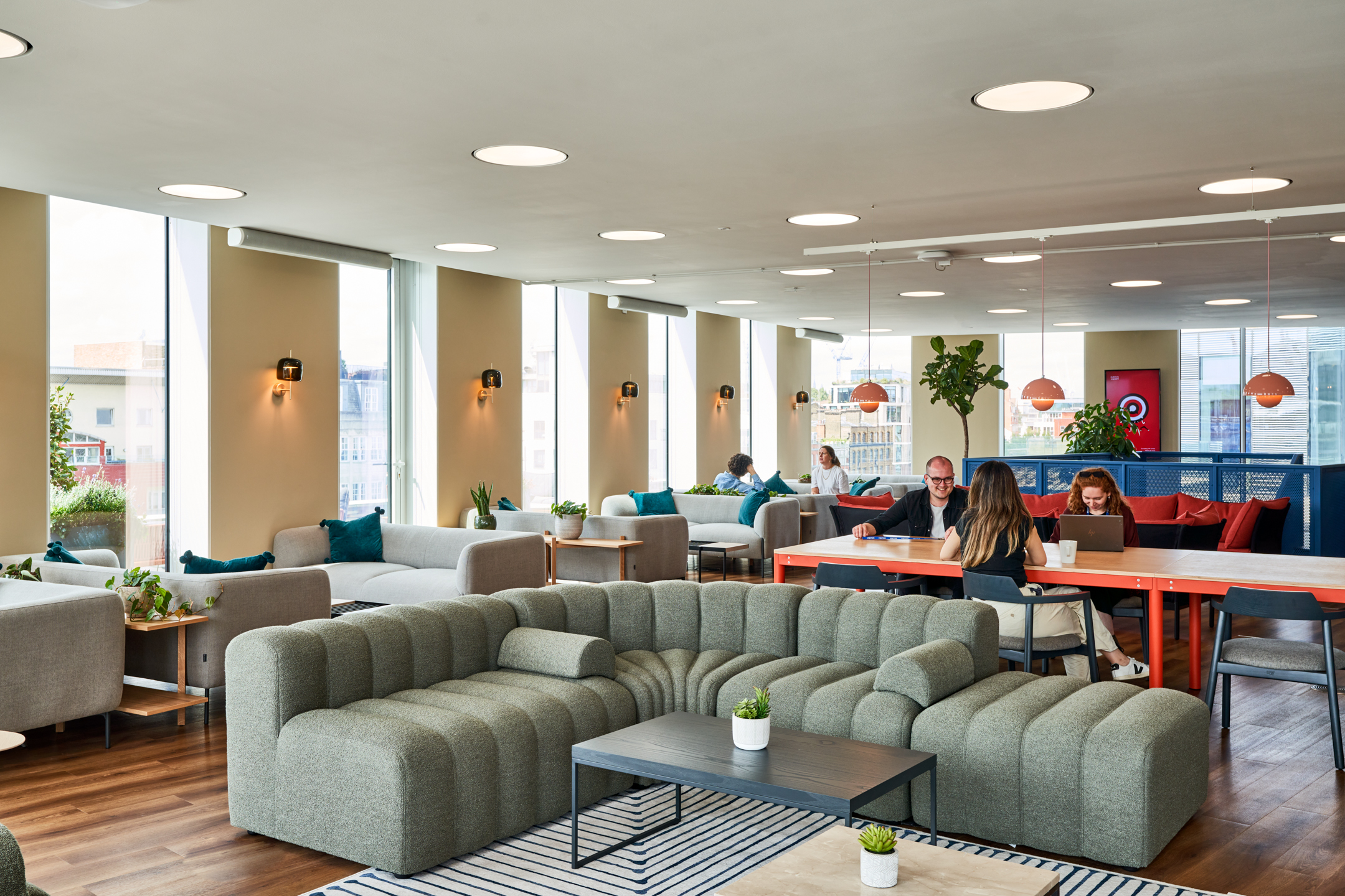 Lounge and collaborative work areas at Publicis Sapient, furnished by Platfform with modular sofas, long communal tables and layered soft seating in a bright, open-plan space.