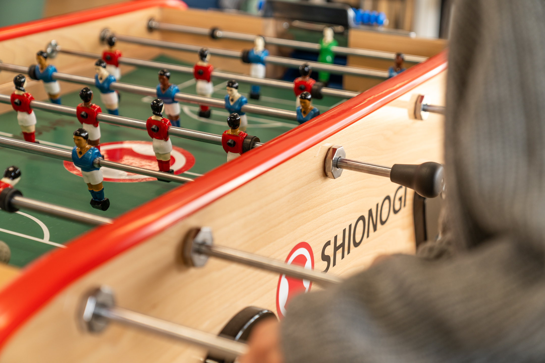 Foosball table in Shionogi’s social zone, part of a workspace designed with balance in mind, where moments of play meet Japandi calm.