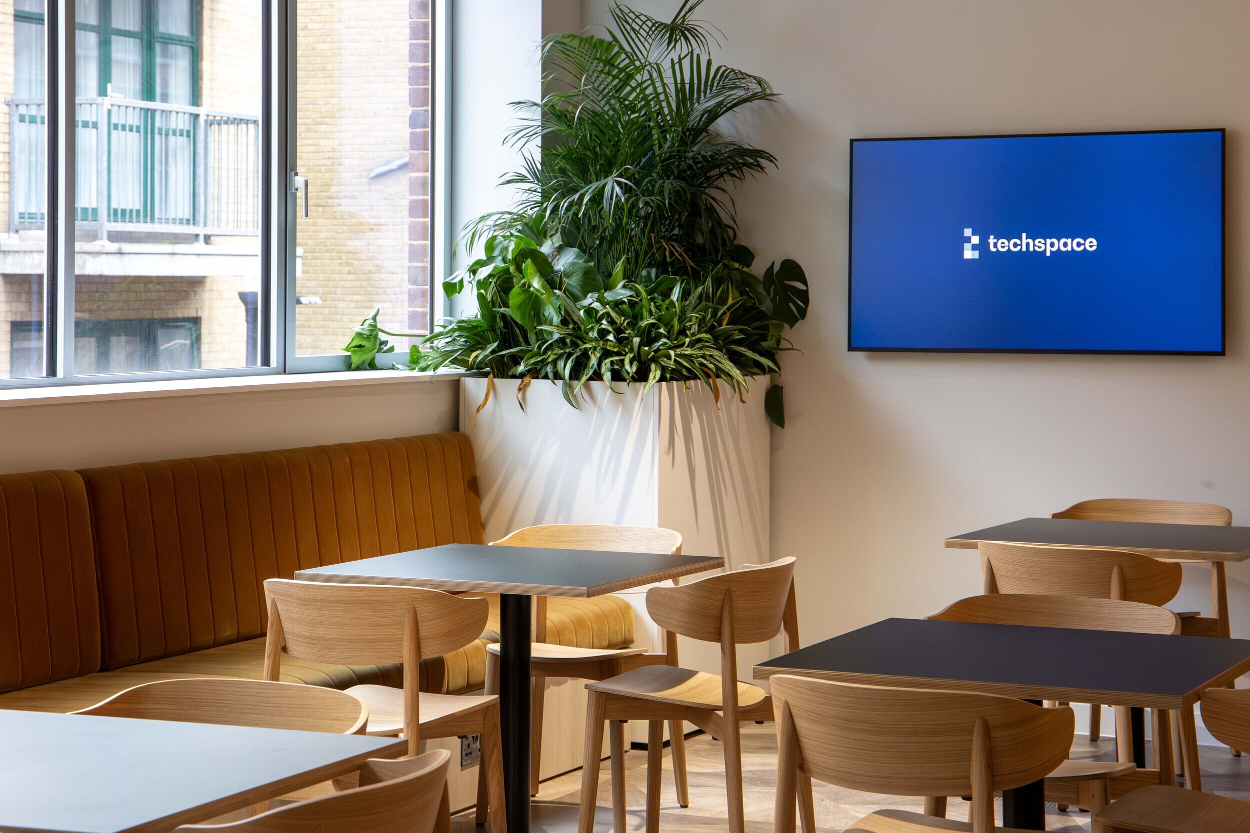 Techspace breakout space with booth seating tables and chairs supplied for relaxed working and team moments