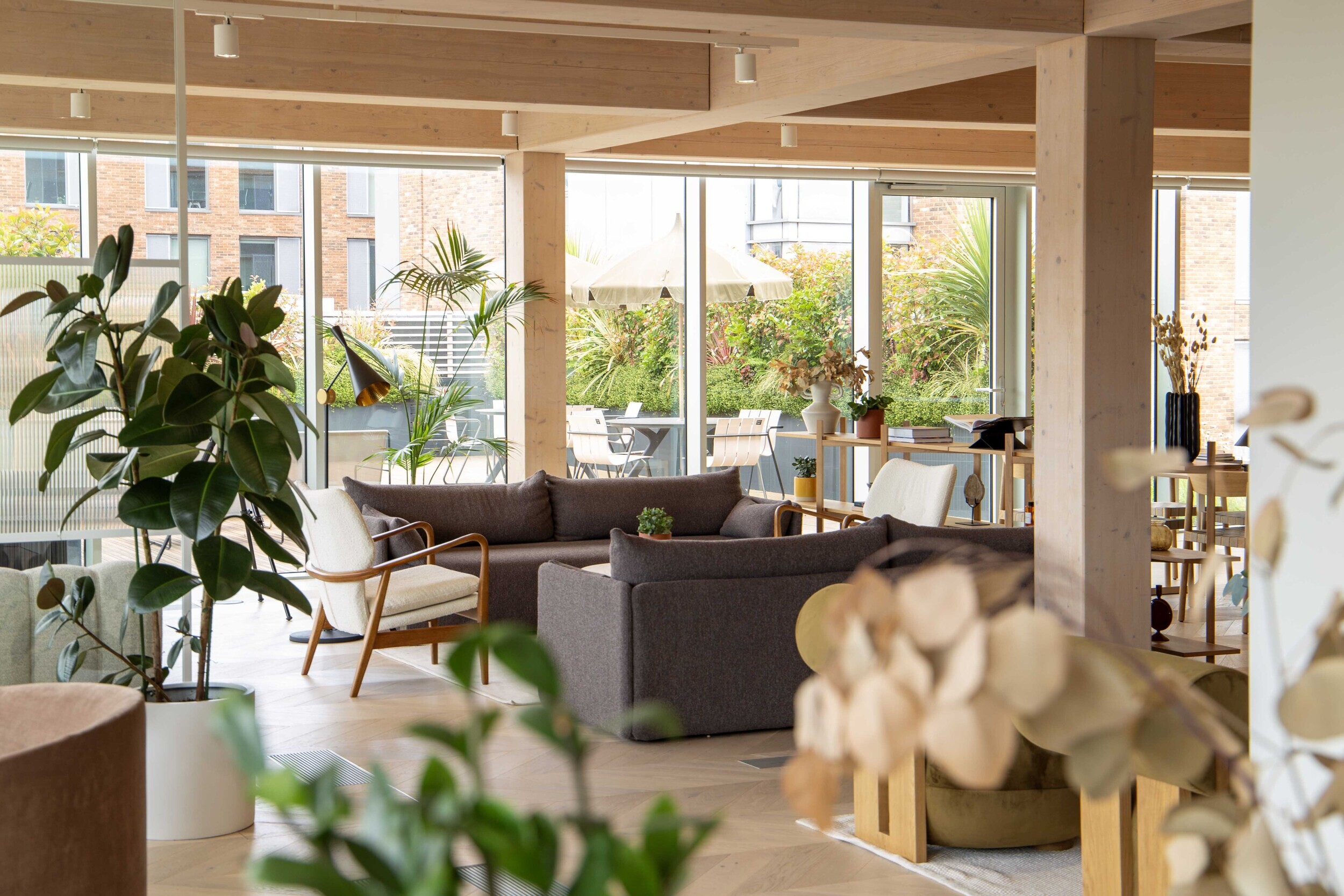 Techspace breakout space with soft seating lounge chairs and greenery designed for informal working and social time