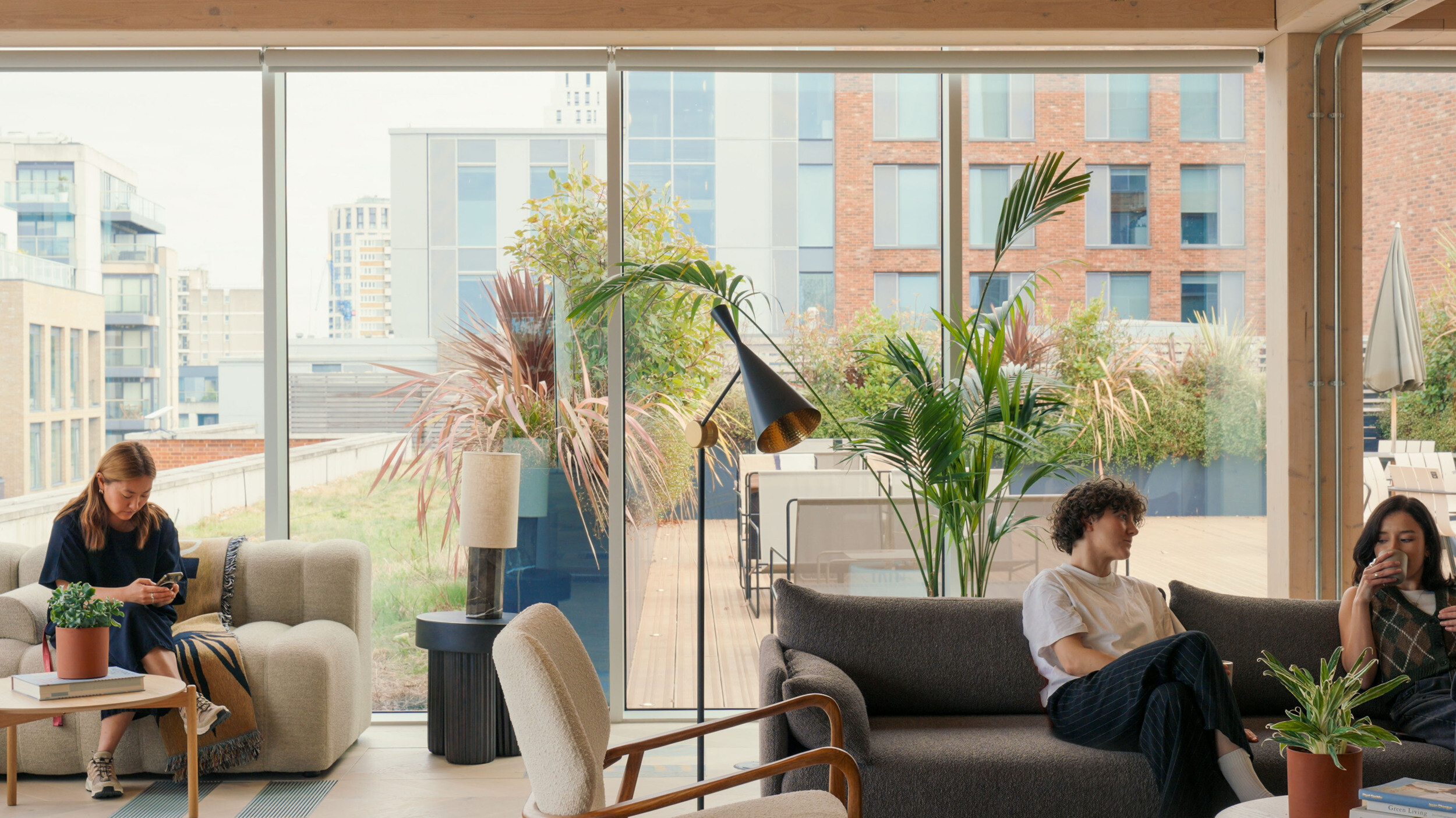 Techspace lounge area with people using soft seating and armchairs designed for informal meetings and solo work and collab.
