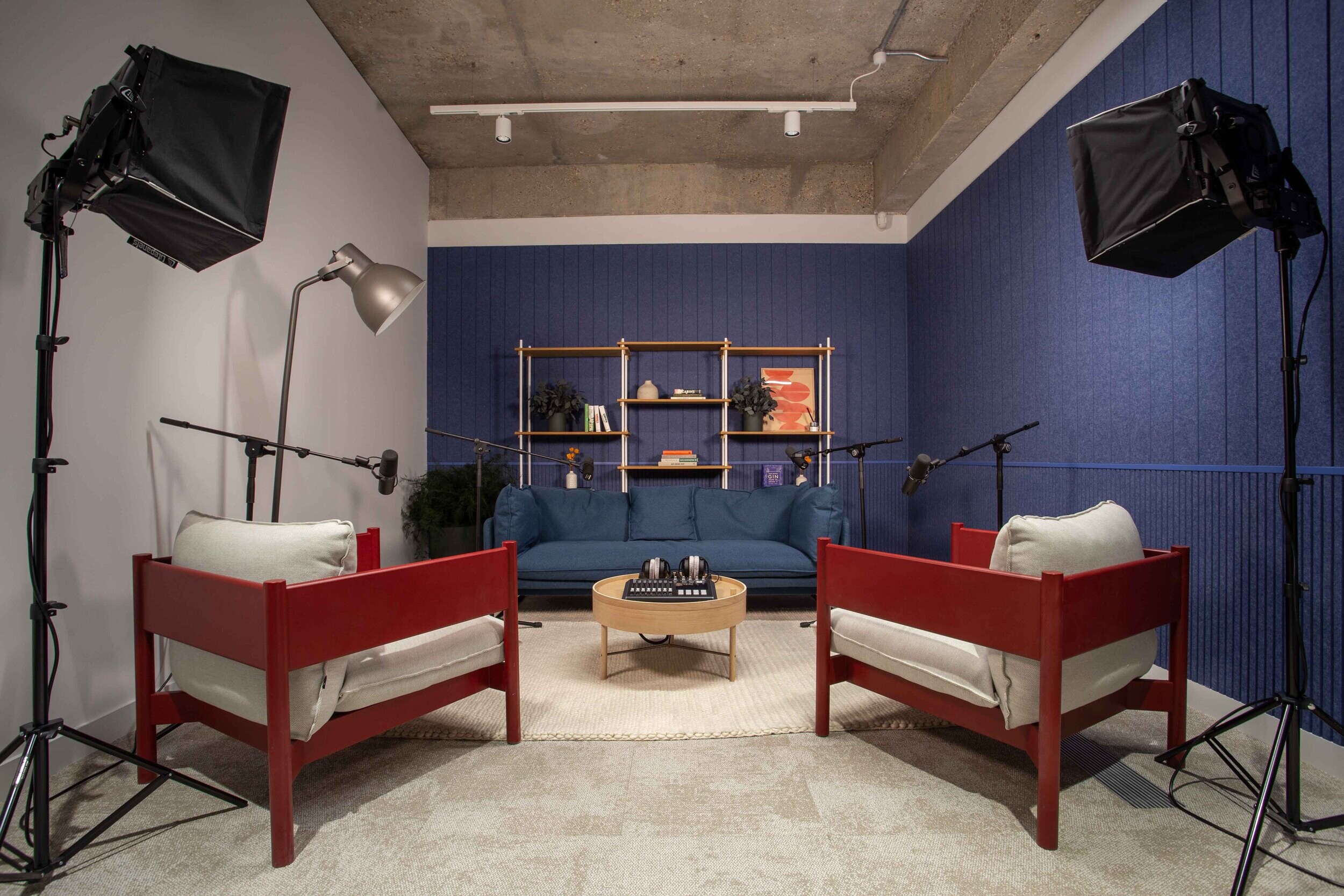 Techspace studio space with soft seating microphones and lighting designed for podcasting and video content creation