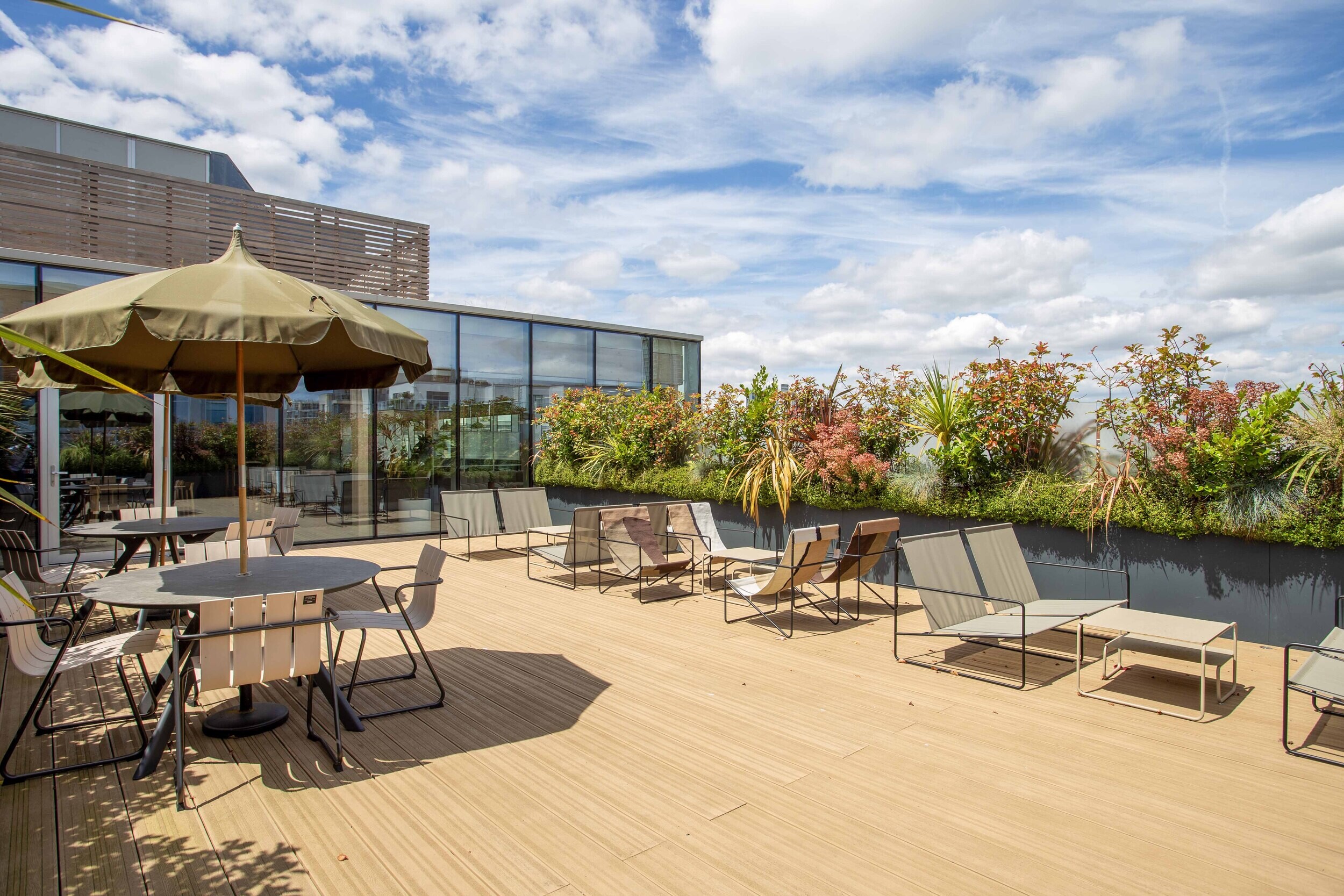 Techspace terrace with outdoor seating and loungers set among planting for open air working and relaxation