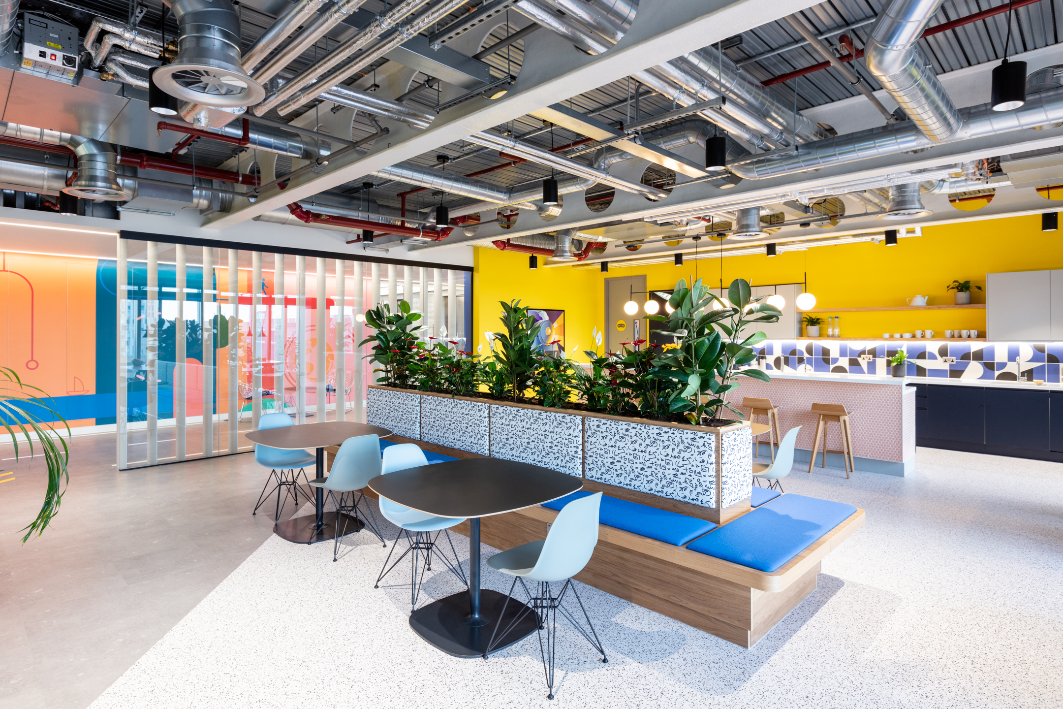 Travelfusion breakout area with Platfform-supplied café seating, planters and pops of colour to reflect the bold and agile workspace design.
