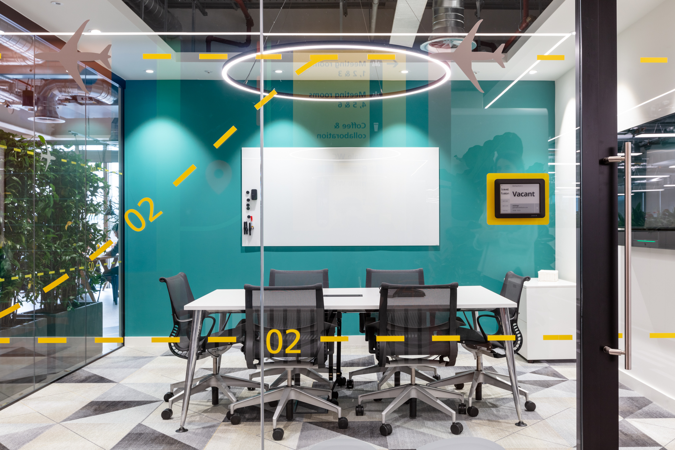 Travelfusion meeting room featuring Platfform-sourced ergonomic task chairs and collaborative furniture, styled to match the office’s aviation-inspired theme.