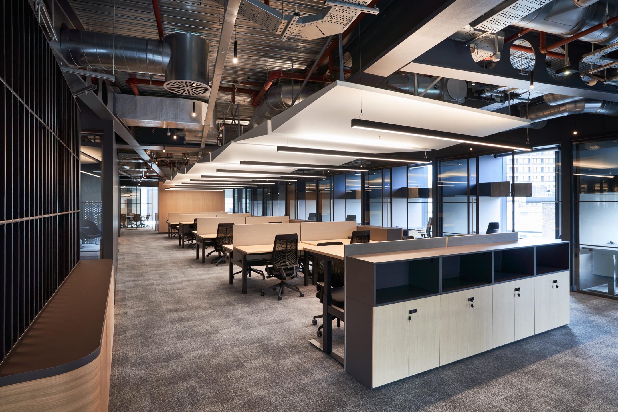 Furniture by Platfform in United Talent Agency’s London office includes open bench desks, integrated storage and zoned layout for flexible team setups.