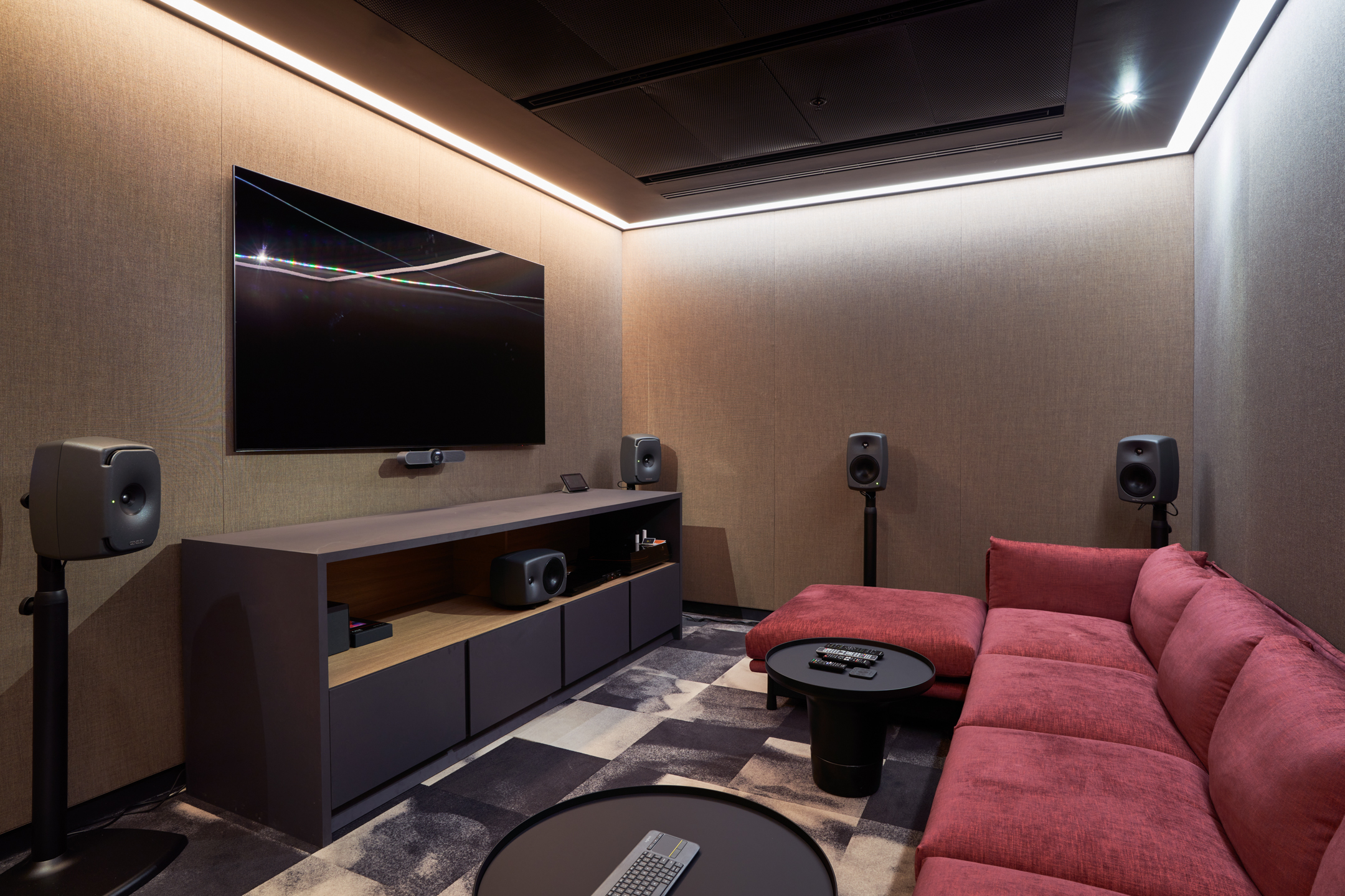 AV suite at United Talent Agency with a rich red lounge sofa and custom media unit, furnished by Platfform for focused screening and sound clarity.
